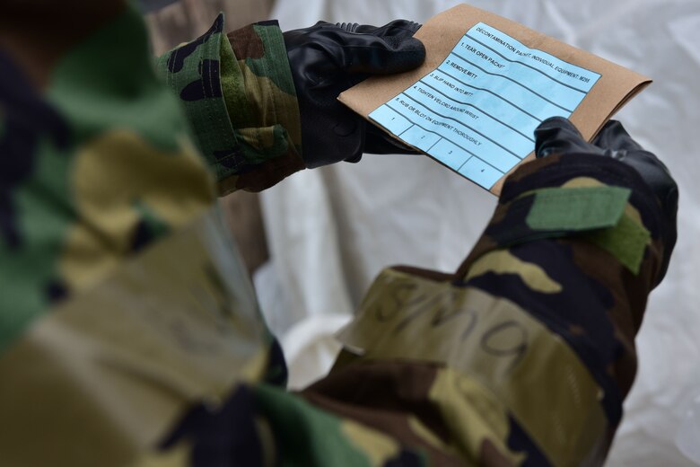 Airmen looks at decontamination package