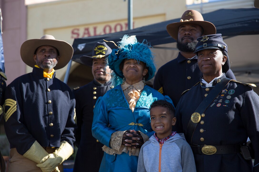 Civilians with the Buffalo Soldiers of the Arizona Territory and Ladies and Gentlemen of the Regiment pose for a group photo during Yuma Military Appreciation Day in Downtown Historic Yuma on Feb. 16, 2019. Military Appreciation Day is held to show the importance of the relationship between the City of Yuma and our service members and veterans. (U.S. Marine Corps photo by Sgt. Allison Lotz)