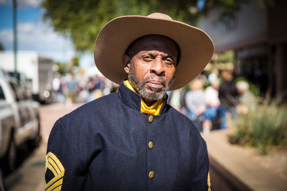 A Civilian with the Buffalo Soldiers of the Arizona Territory and Ladies and Gentlemen of the Regiment pose for a portrait photo during Yuma Military Appreciation Day in Downtown Historic Yuma on Feb. 16, 2019. Military Appreciation Day is held to show the importance of the relationship between the City of Yuma and our service members and veterans. (U.S. Marine Corps photo by Sgt. Allison Lotz)