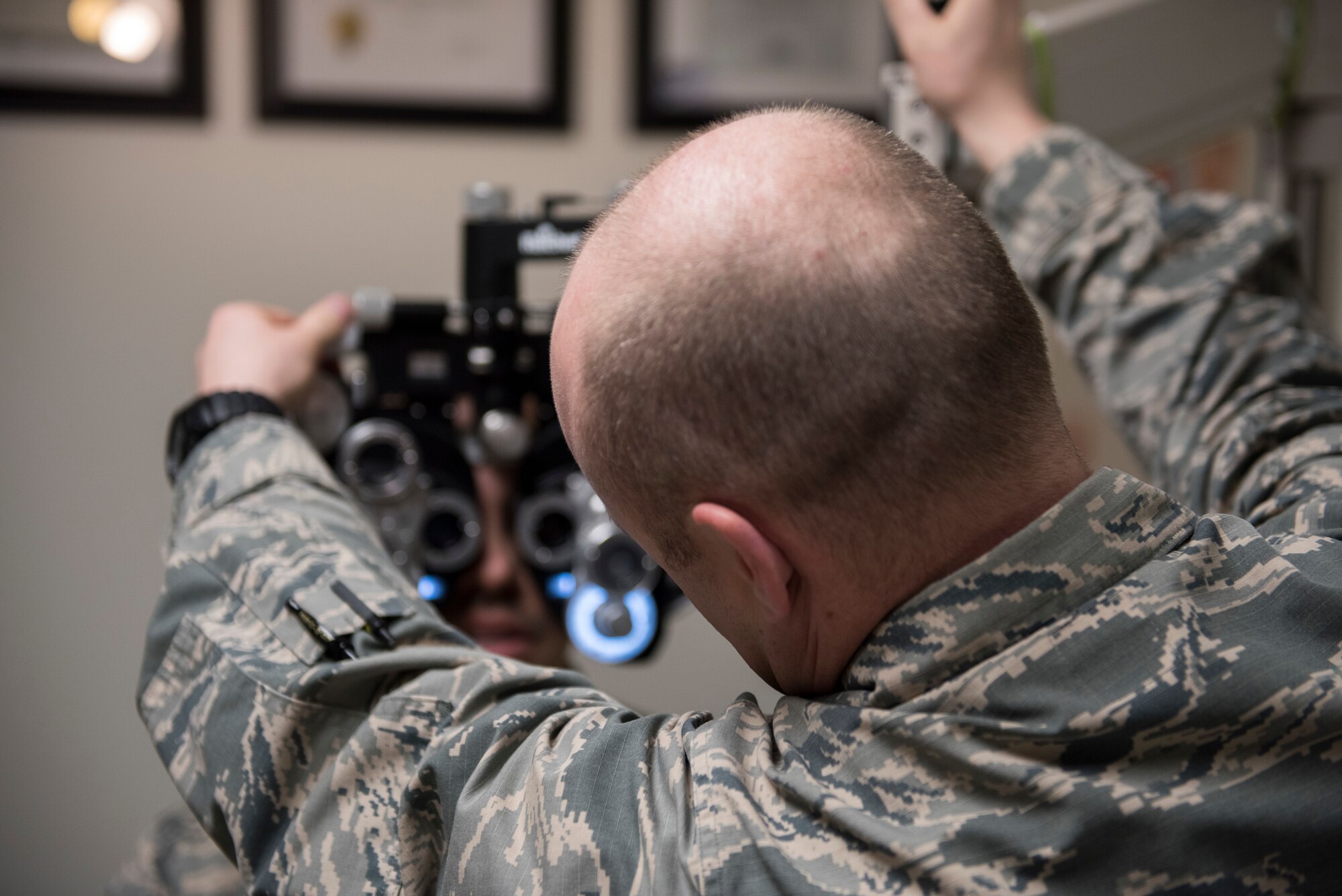 Capt. Craig Jensen, 366th Aerospace Medical Squadron optometry flight commander, performs a vision test on a patient, Feb, 25, 2019 at Mountain Home Air Force Base, Idaho. The 366th AMDS optometry clinic provides Airmen quality care all year to ensure they can see and accomplish the Air Force mission. (U.S. Air Force photo by Airman 1st Class Hailey Bivens)