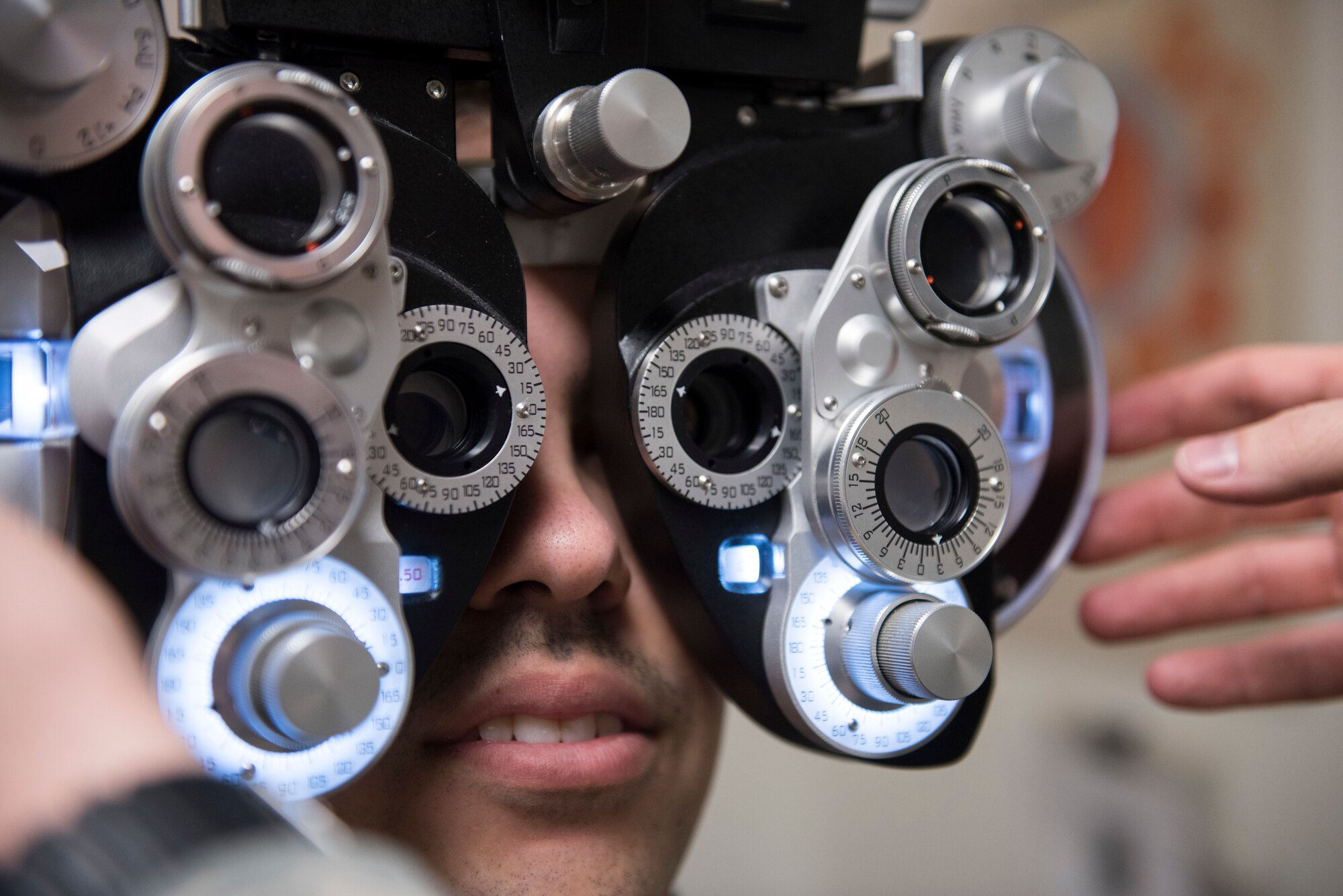 Capt. Craig Jensen, 366th Aerospace Medical Squadron optometry flight commander, performs a vision test on a patient, Feb, 25, 2019 at Mountain Home Air Force Base, Idaho. The 366th AMDS optometry clinic provides Airmen quality care all year to ensure they can see and accomplish the Air Force mission. (U.S. Air Force photo by Airman 1st Class Hailey Bivens)