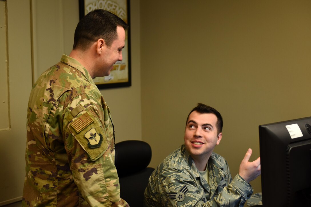 Master Sgt. Kevin McGinnis, 14th Civil Engineer Squadron Readiness and Emergency Management Flight superintendent, and Senior Airman Jacob Russo, 14th CES Readiness and Emergency Management Flight journeyman, discuss how to order training equipment Feb. 26, 2019, on Columbus Air Force Base, Mississippi. McGinnis and his team are charged with ensuring that all base personnel are fully trained to minimize casualties and damage in the event of a disaster or attack. (U.S. Air Force photo by Senior Airman Beaux Hebert)