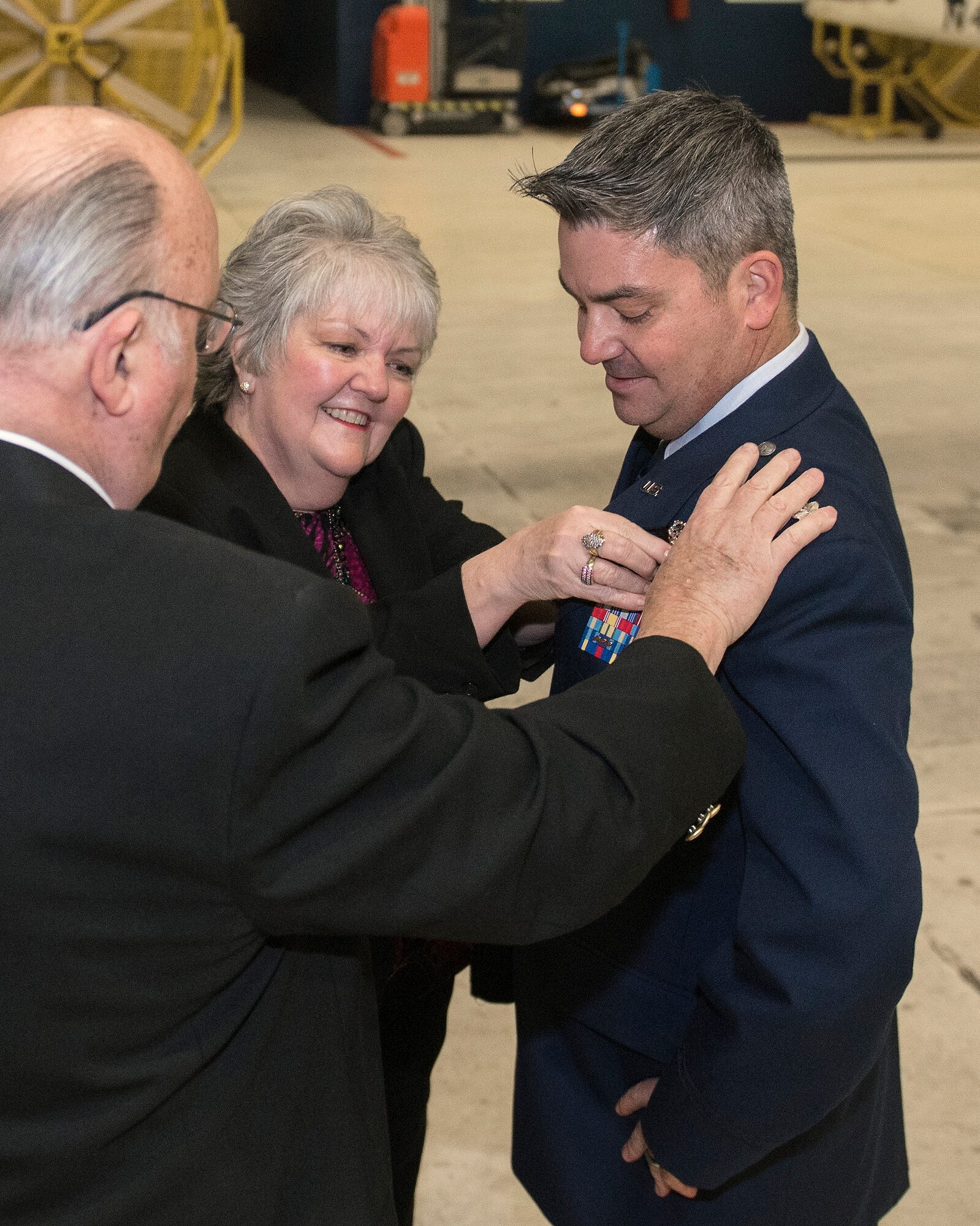 Dennis and Ruth Barmore pin a maintenance badge on the uniform of their son, Lt. Col. Harley Barmore, during an informal ceremony inside the Bennie L. Davis Maintenance Facility February 15, 2019 at Offutt Air Force Base, Nebraska. Lt. Col. Barmore’s parents, who were former Air Force maintainers, traveled from Arizona to visit their son who was recently appointed as the 55th Maintenance Group deputy commander. (U.S. Air Force photo by Delanie Stafford)