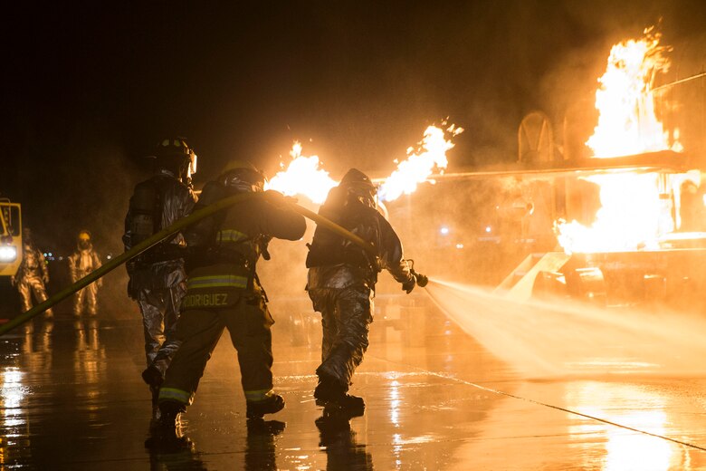U.S. Marines with Aircraft Rescue and Fire Fighting (ARFF) conduct Hand Line Drills at Marine Corps Air Station (MCAS) Yuma Feb. 15, 2019. These drills focus on techniques to push fuel fires away from aircraft and simulate large aircraft fire fighting. The Marines train monthly to enhance their readiness when responding to hazards or emergencies on the flight line. (U.S. Marine Corps photo by Cpl. Sabrina Candiaflores)