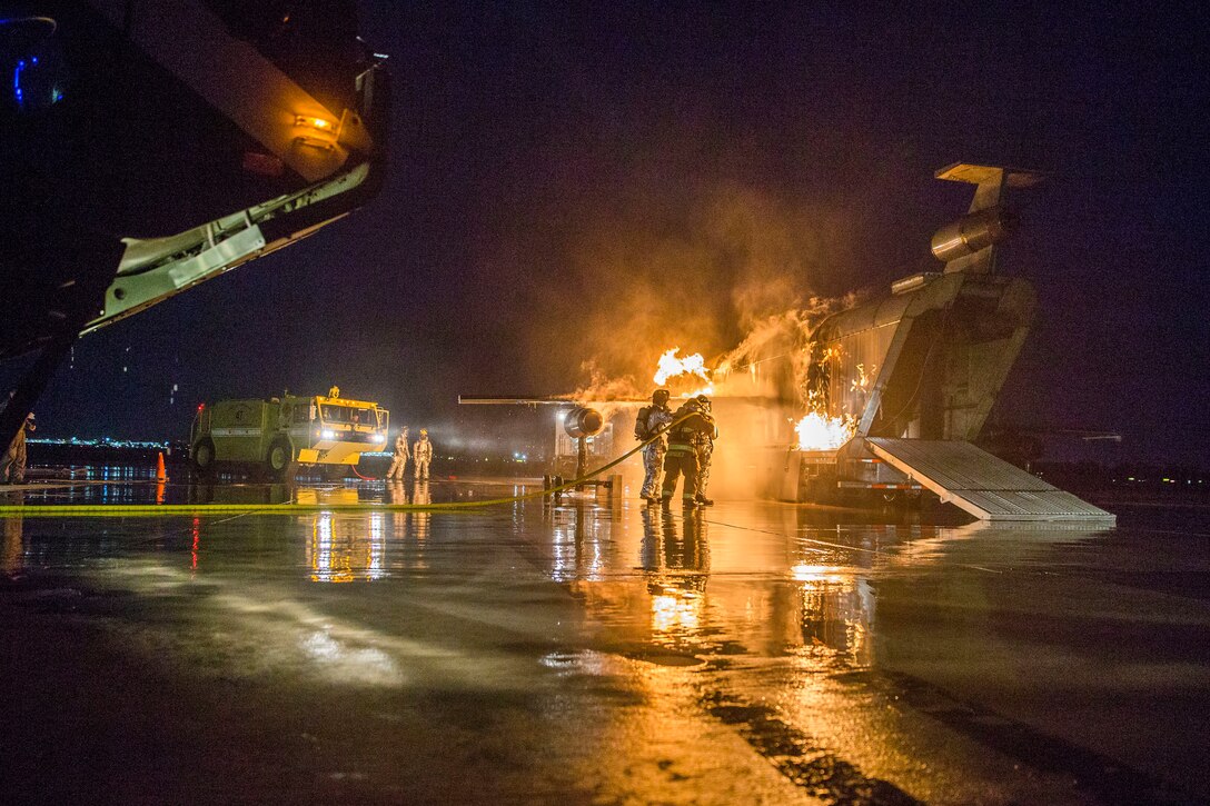 U.S. Marines with Aircraft Rescue and Fire Fighting (ARFF) conduct Hand Line Drills at Marine Corps Air Station (MCAS) Yuma Feb. 15, 2019. These drills focus on techniques to push fuel fires away from aircraft and simulate large aircraft fire fighting. The Marines train monthly to enhance their readiness when responding to hazards or emergencies on the flight line. (U.S. Marine Corps photo by Cpl. Sabrina Candiaflores)