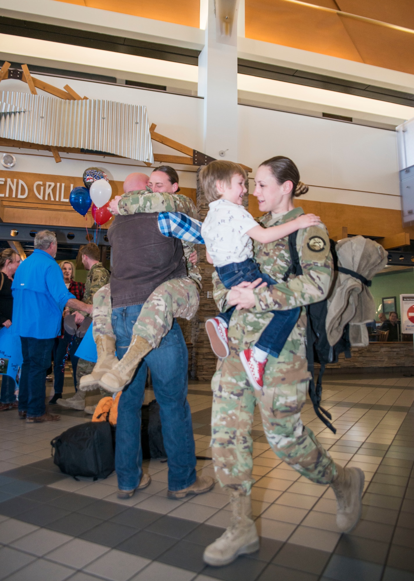 An aerial porter with the 96th Aerial Port Squadron, 913th Airlift Group, Little Rock Air Force Base, Ark. greets family and friends at the local airport. During the week of Feb. 20, 2019, more than 15 Reserve Citizen Airmen returned from various deployments from across Southwest Asia. The Airmen inspect and palletize all cargo before shipment. They also work closely with aircraft loadmasters to carefully position the cargo inside aircraft. (U.S. Air Force photo Capt. Ashley Walker)