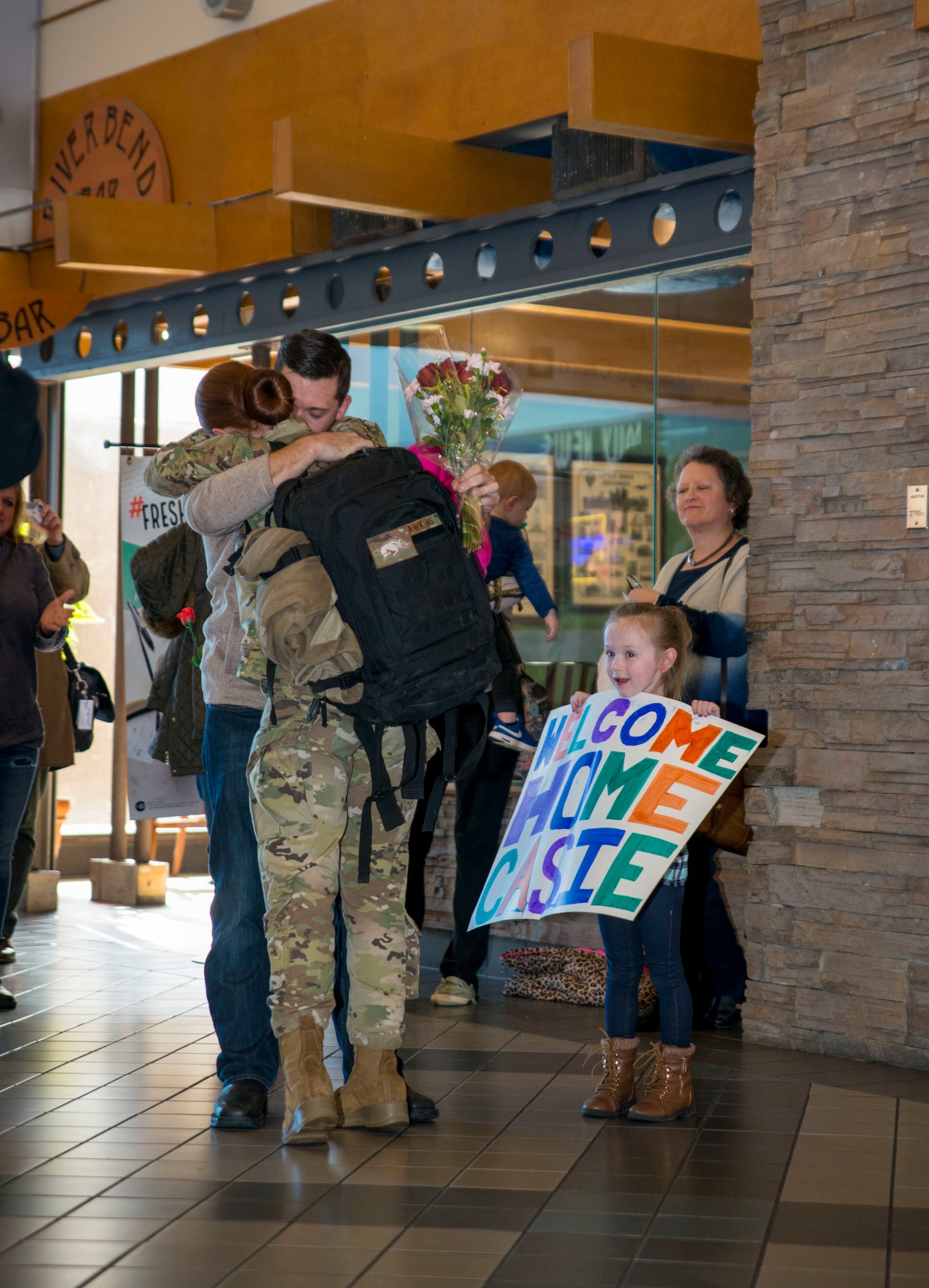 An aerial porter with the 96th Aerial Port Squadron, 913th Airlift Group, Little Rock Air Force Base, Ark. greets family and friends at the local airport. During the week of Feb. 20, 2019, more than 15 Reserve Citizen Airmen returned from various deployments from across Southwest Asia. The Airmen inspect and palletize all cargo before shipment. They also work closely with aircraft loadmasters to carefully position the cargo inside aircraft. (U.S. Air Force photo Capt. Ashley Walker)