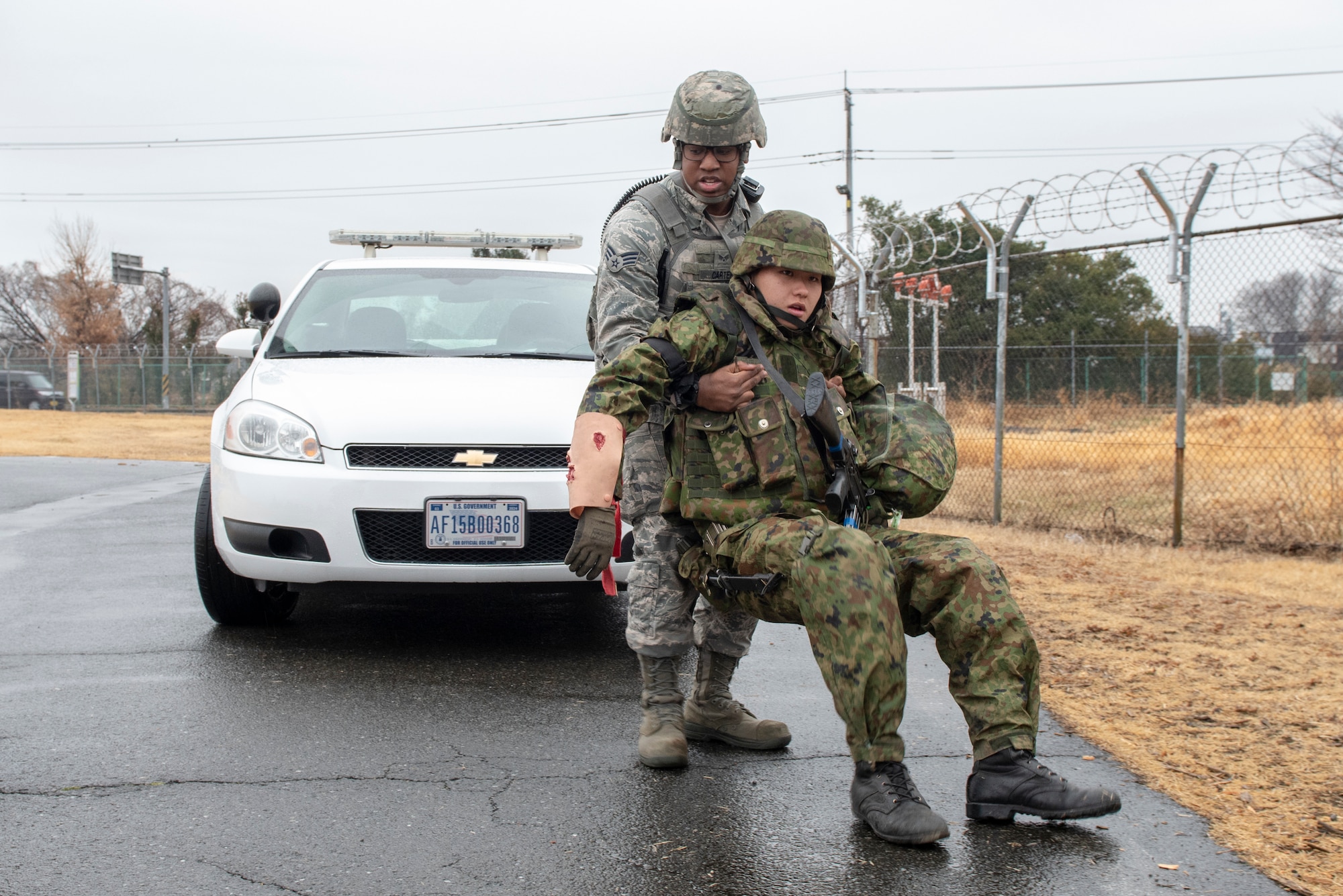 Senior Airman Clifton Carter, 374th Security Forces Squadron patrolman, pulls an injured teammate to safety during Guard and Protect 2019 at Yokota Air Base, Japan, Feb. 28, 2019.