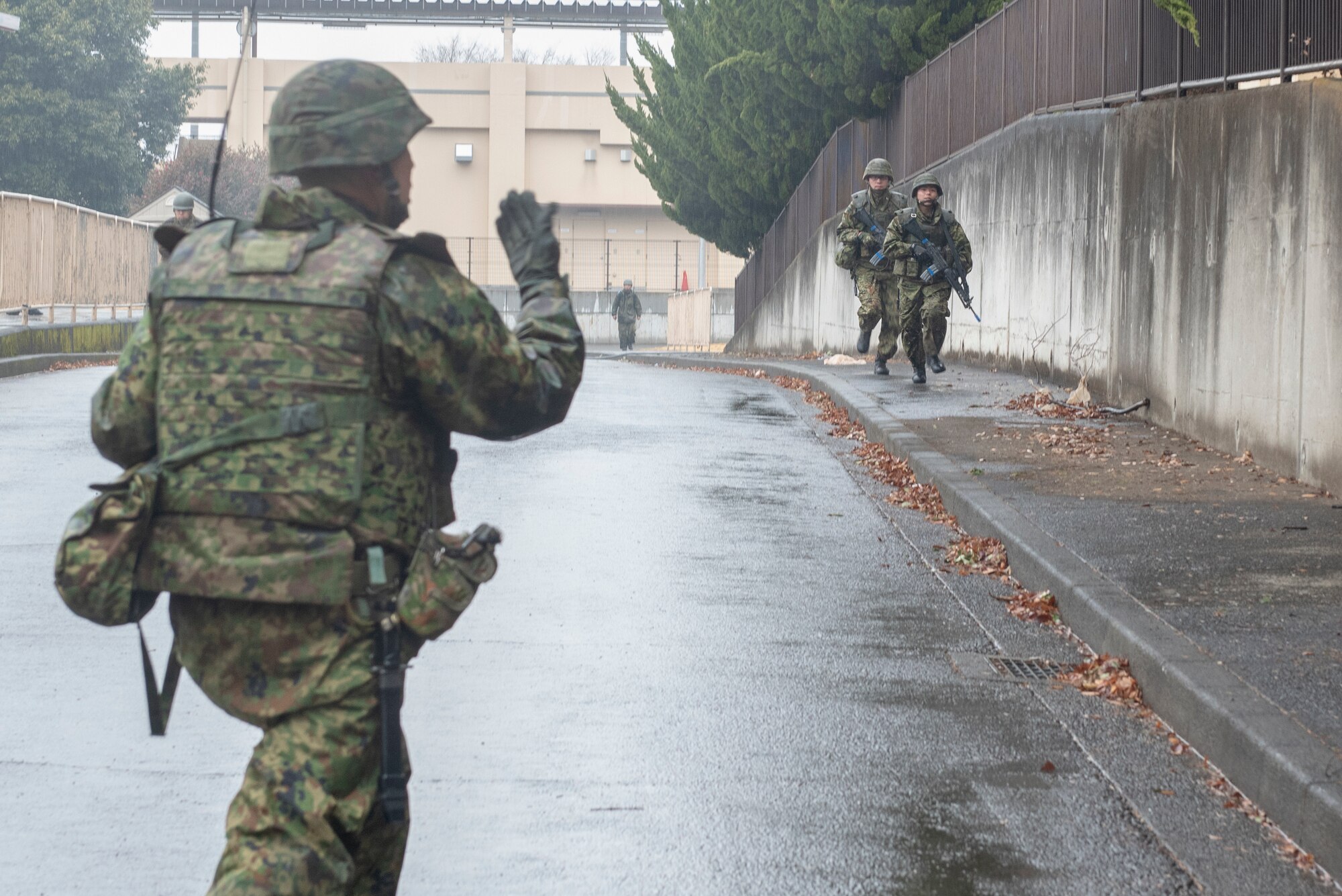 Members of the Japan Ground Self-Defense Force (JGSDF) from the 34th Infantry Regiment out of Camp Itazuma in Gotemba, Japan move into position to secure the area during Guard and Protect 2019 at Yokota Air Base, Japan, Feb. 28, 2019.