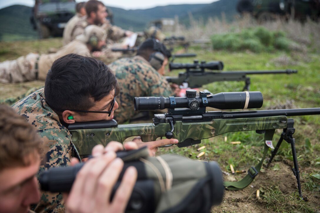U.S. Marines with Special Purpose Marine Air-Ground Task Force-Crisis Response-Africa and Spanish reconnaissance soldiers fire M40 A6 and SAS M110 sniper rifles during a training event in Sierra De Retin, Spain, Dec.