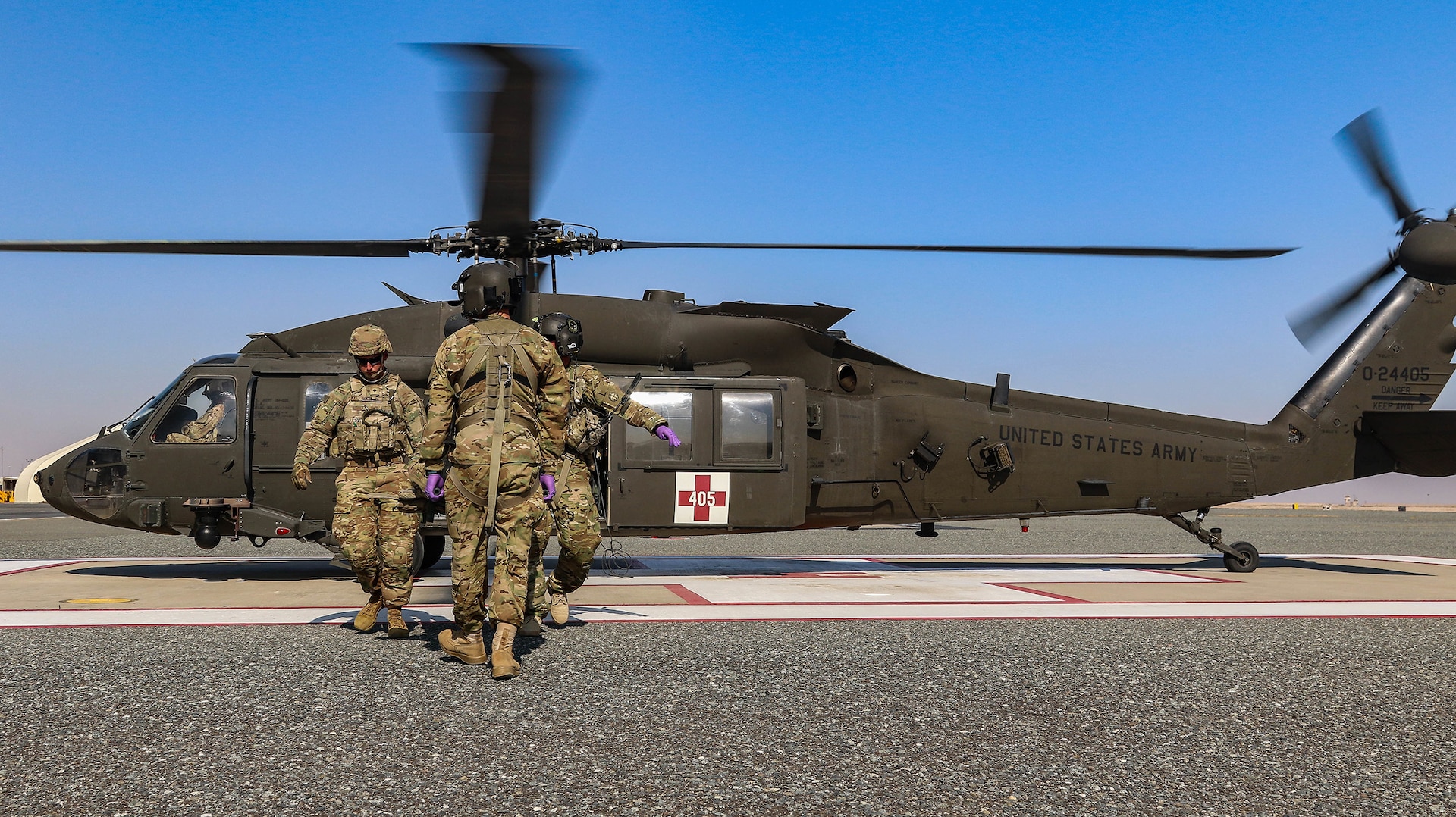 U.S. Army Soldiers assigned to the 2-211th General Support Aviation Battalion, Minnesota Army National Guard, and the 155th Armored Brigade Combat Team, Mississippi Army National Guard, pull a patient from a UH-60L Black Hawk helicopter during an aeromedical evacuation rehearsal at Camp Buehring, Kuwait, Dec. 11, 2018.