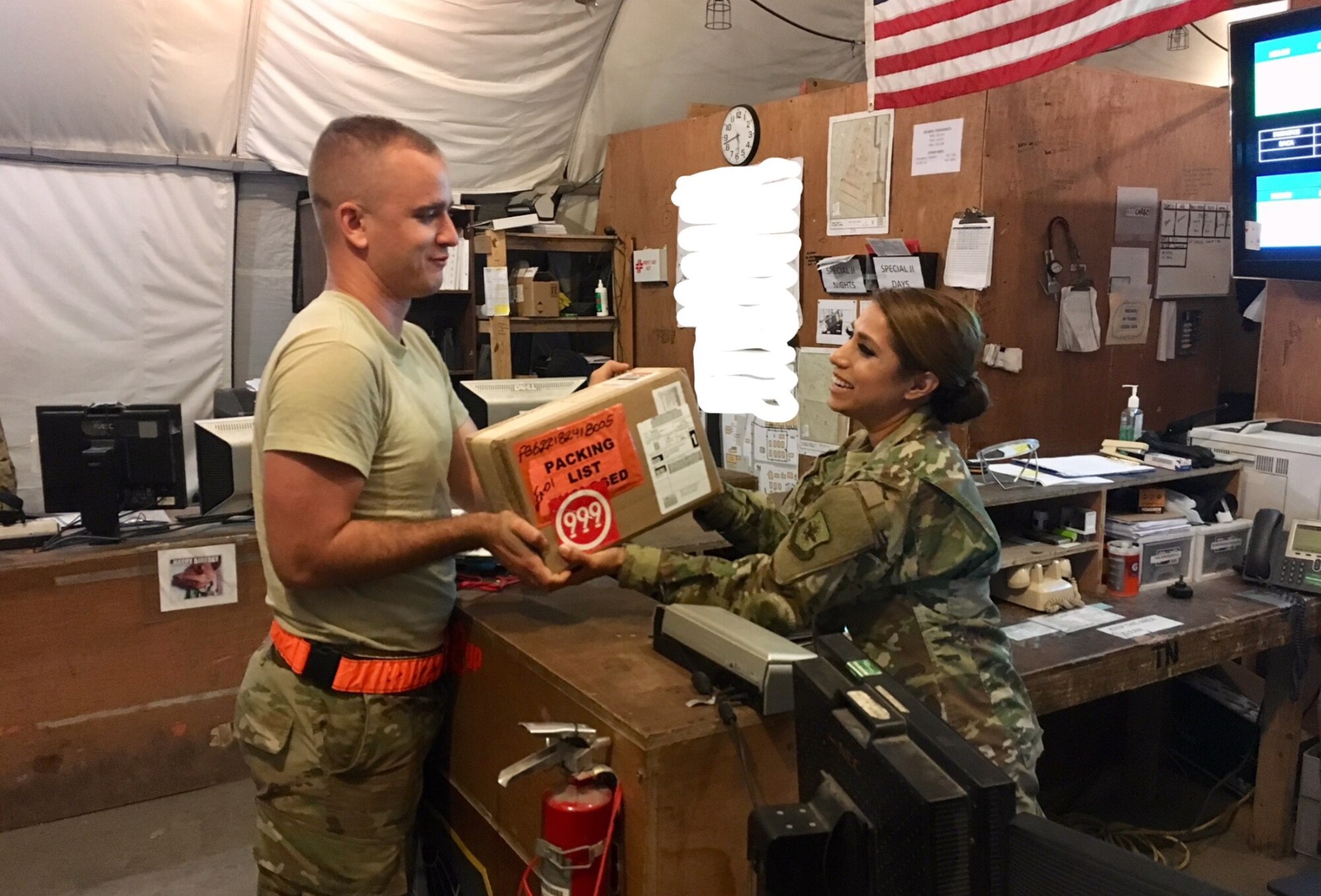 Tech. Sgt. Janet Lindsay, Special Cargo Handler, 8th Expeditionary Air Mobility Squadron, receives a package at Al Udeid Air Base in Qatar.