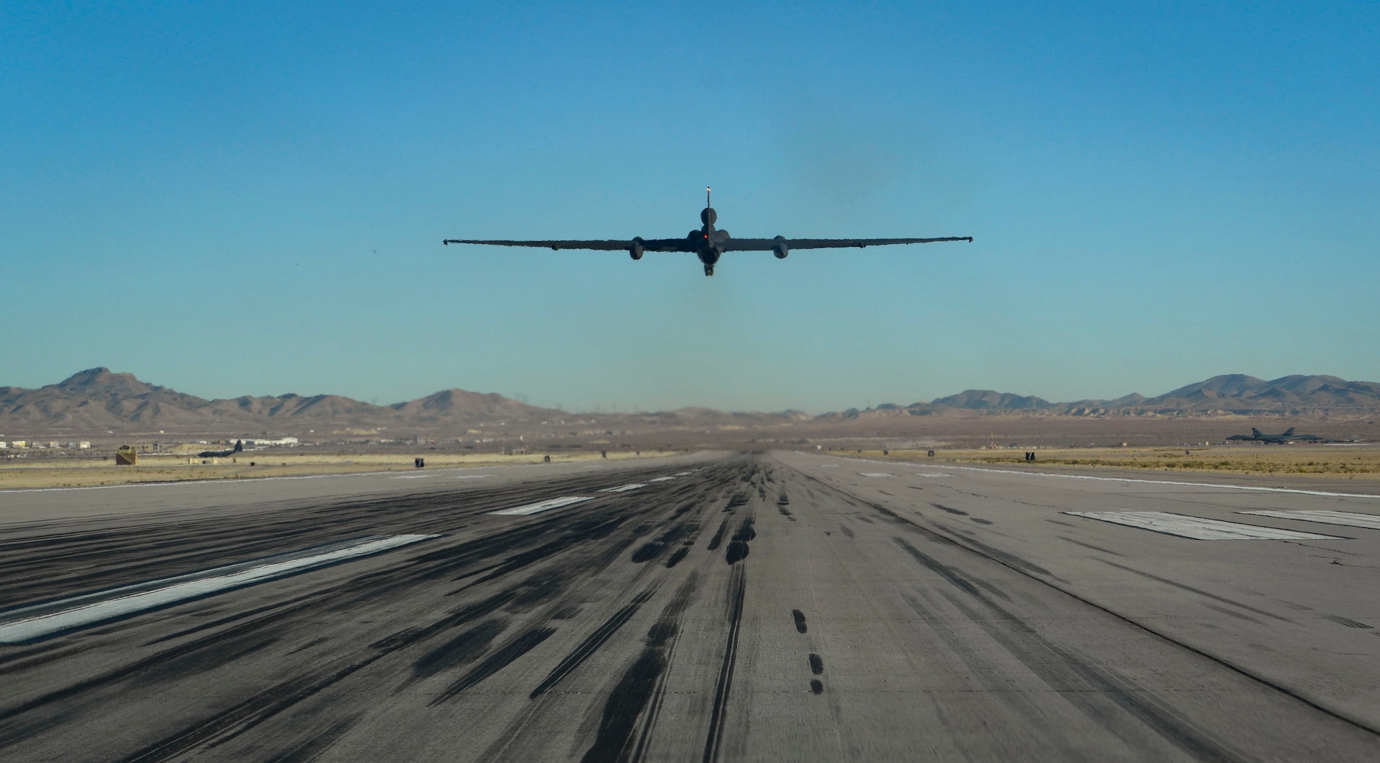 An aircraft flies straight up from the flight line.