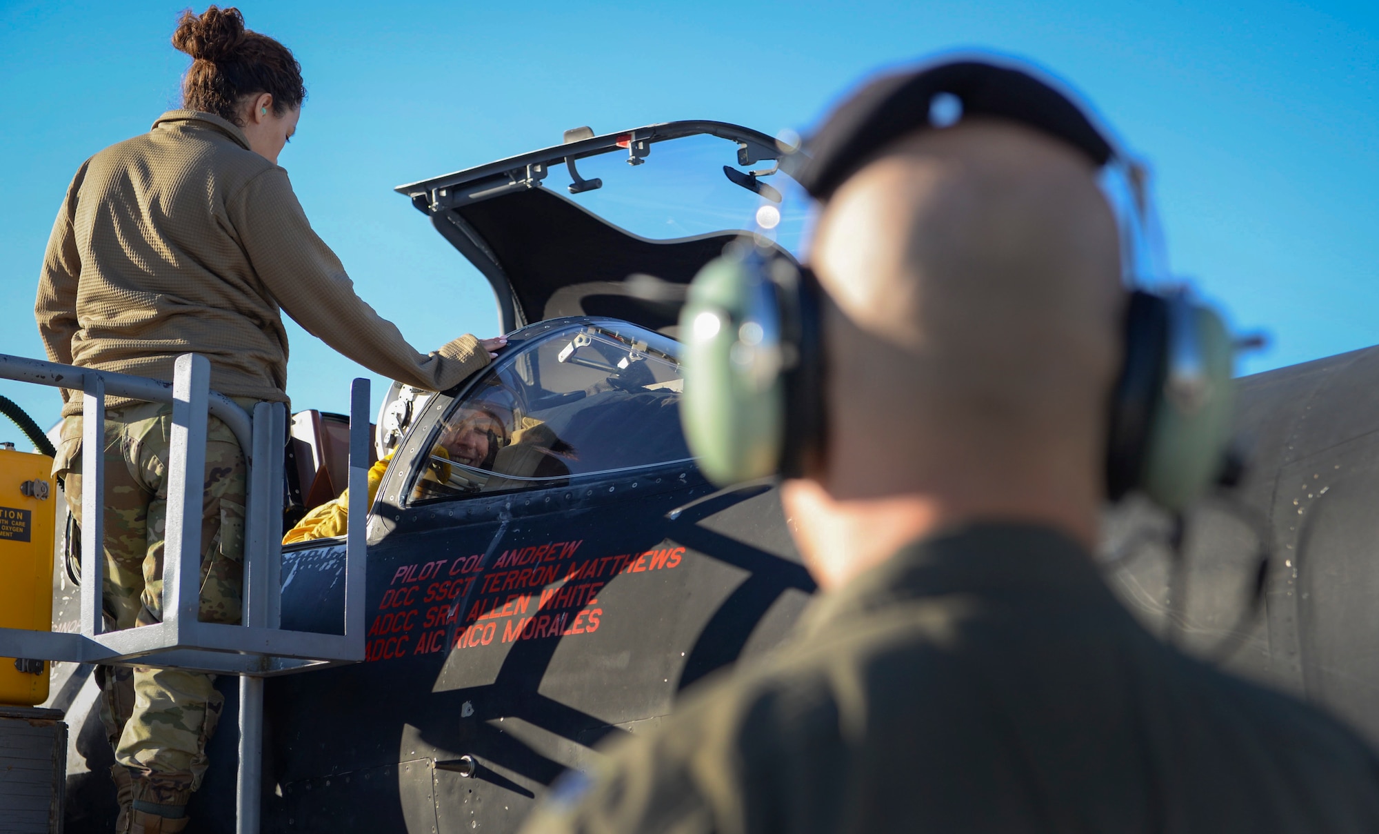 An Airman prepares a pilot for flight.