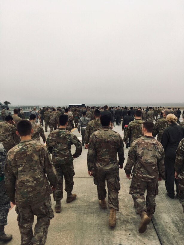 Team Moody Airmen make their way back after picking up debris during a foreign object debris (FOD) walk, Jan. 2, 2019, at Moody Air Force Base, Ga. Team Moody started the New Year with a clean slate by picking up debris off the flightline this morning, ensuring a safe runway for training and deploying warriors throughout the year. We also had the honor of hearing guest speaker Bernie McGrenahan, a comedian with a powerful training and prevention-based session at the end of his show. Thank you to the Wing Safety Office for putting this day together and starting the year off right! (U.S. Air Force photo by Airman 1st Class Erick Requadt)