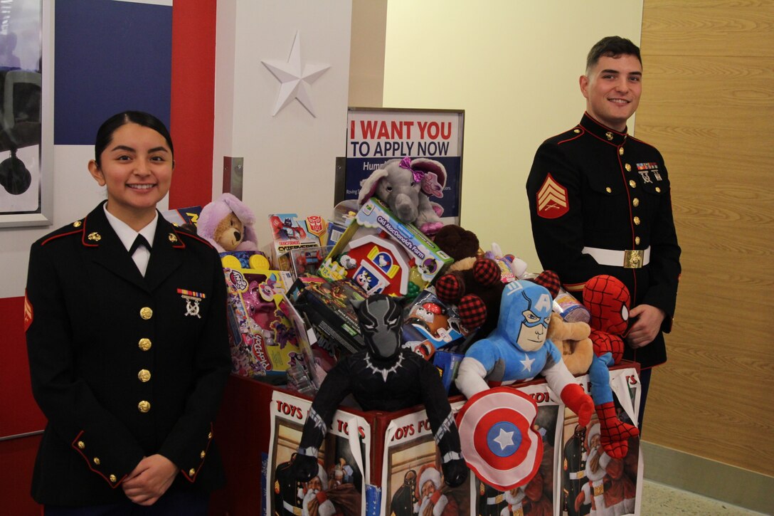 CAMP HUMPHREYS, Republic of Korea – Sgt. Michael Parent, G2 Systems Chief, and Cpl. Cecilia Santuario, G1 Administration Clerk, collect toys during the U.S. Marine Corps Forces Korea Toys for Tots effort here, Dec. 22.  MARFORK collected several thousand toys throughout the 2018 holiday season and delivered them to thirteen orphanages in Seoul and Pyeongtaek.