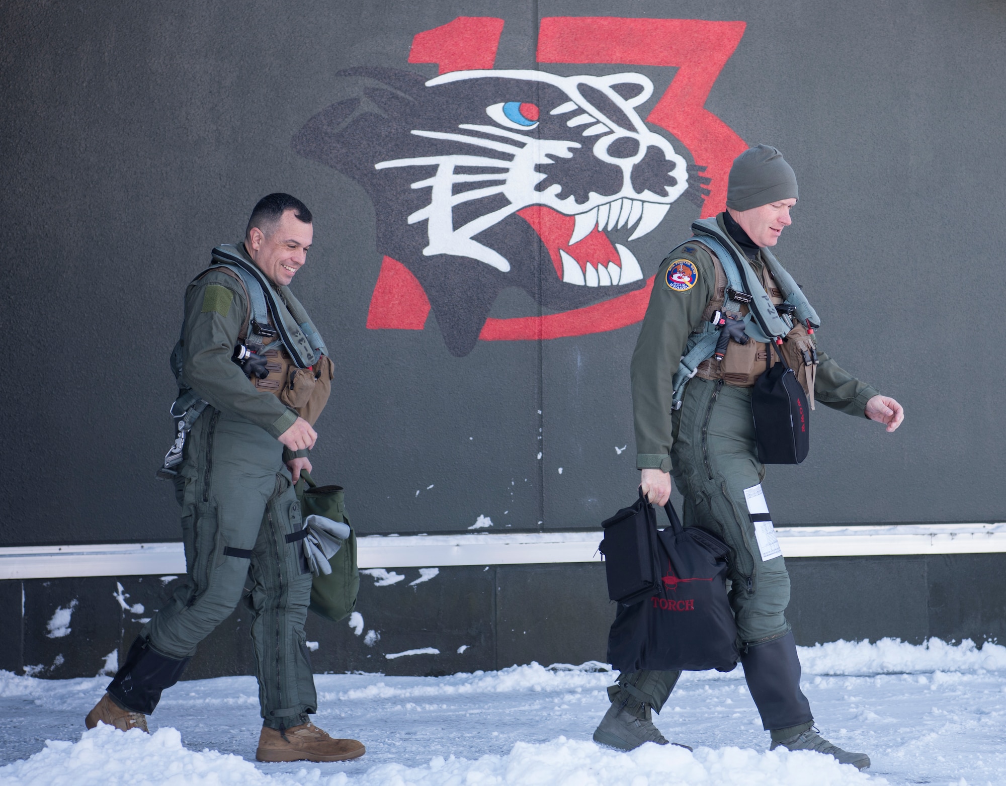 U.S. Air Force Col. Kristopher Struve, right, the 35th Fighter Wing commander, and Chief Master Sgt. John Alsvig, left, the 35th FW command chief, walk out of the 13th Fighter Squadron at Misawa Air Base, Japan, Dec. 28, 1018. Struve, a seasoned F-16 Fighting Falcon pilot with more than 2,500 flying hours, gave Alsvig a familiarization flight, allowing him to see first hand what pilots endure during a routine flight. (U.S. Air Force photo by Staff Sgt. B.A. Chase)