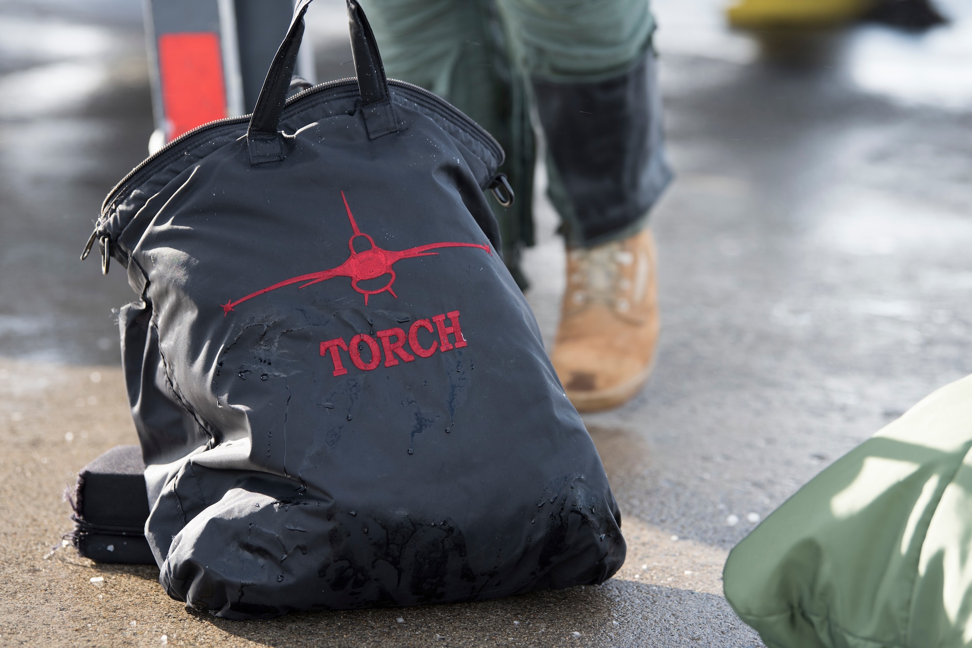 A helmet bag belonging to U.S. Air Force Col. Kristopher Struve, the 35th Fighter Wing commander, lays on the ground at Misawa Air Base, Japan, Dec. 28, 1018. "Torch" is Struve's callsign, which is a specalized form of nickname that is used as a substitue for the aviators given name. He gave U.S. Air Force Chief Master Sgt. John Alsvig, the 35th FW command chief, a familiarization flight allowing him to see the ins and outs of the functions of the F-16 Fighting Falcon. (U.S. Air Force photo by Staff Sgt. B.A. Chase)