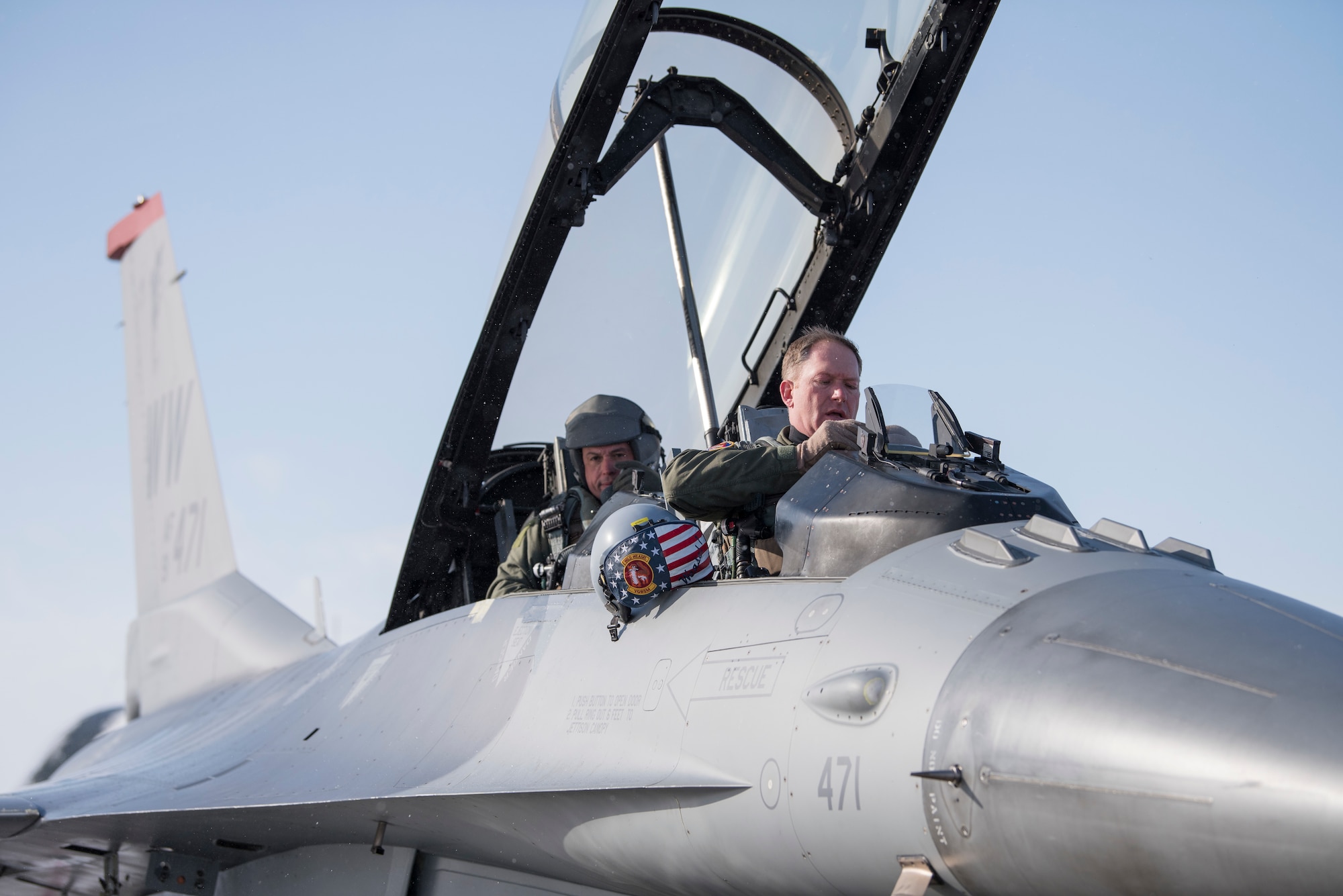 U.S. Air Force Col. Kristopher Struve, right, the 35th Fighter Wing commander, and Chief Master Sgt. John Alsvig, left, the 35th FW command chief, sit in an F-16 Fighting Falcon at Misawa Air Base, Japan, Dec. 28, 1018. Struve, a seasoned F-16 Fighting Falcon pilot with more than 2,500 flying hours, gave Alsvig a familiarization flight, allowing him to see first hand what pilots endure during a routine flight. (U.S. Air Force photo by Staff Sgt. B.A. Chase)