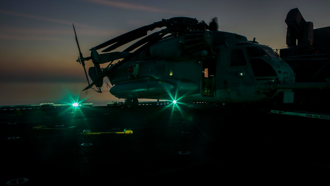 A U.S. Marine CH-53E Super Stallion with Marine Medium Tiltrotor Squadron 166 Reinforced, 13th Marine Expeditionary Unit, is staged aboard the Wasp-class amphibious assault ship USS Essex, Dec. 30, 2018. The Essex is the flagship for the Essex Amphibious Ready Group and, with the embarked 13th MEU, is deployed to the U.S. 5th Fleet area of operations in support of naval operations to ensure maritime stability and security in the Central Region, connecting the Mediterranean and the Pacific through the western Indian Ocean and three strategic choke points.