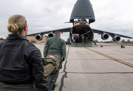 Airmen load simulated patients from a bus onto a C-5M aircraft from Travis Air Force Base, California during a C-5M aeromedical evacuation proof of concept evaluation at Scott Air Force Base, Illinois, Dec. 3, 2018. Active Duty, Reserve and Delaware Air National Guard Airmen worked together during the PoC to test the cargo compartment of the C-5M with the goal of establishing the aircraft as part of the universal qualification training program for all AE crews. If approved and certified, the C-5M will have the capability to move three times the current capacity in one mission compared to other AE platforms.