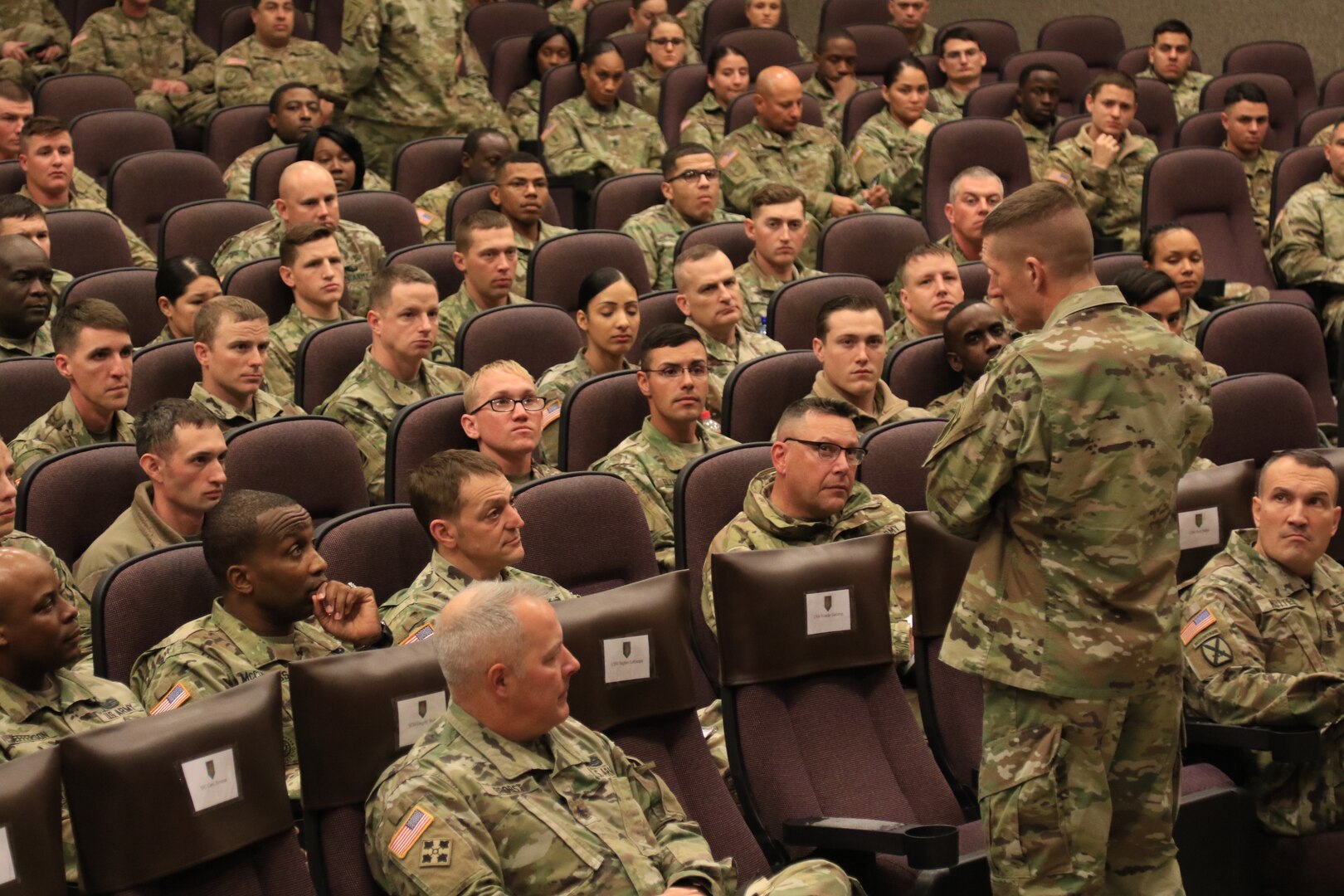 Soldiers of the 1st Infantry Division listen to Sgt. Maj. of the Army Daniel Dailey Nov. 30, 2018, during a question-and-answer session at Barlow Theater, Fort Riley, Kansas. Dailey explained changes coming to the noncommissioned officer education system.