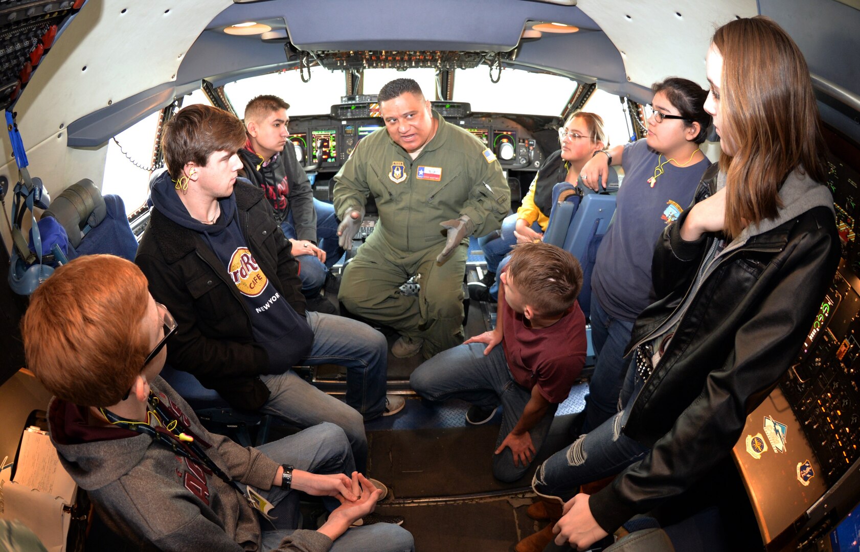 Senior Master Sgt. Steven Martinez, 433rd Operations Group flight engineer, talks to students from Lytle High School about the roles of the C-5M Super Galaxy pilot and the flight engineer during flight, Dec.18, 2018 at Joint Base San Antonio-Lackland.
