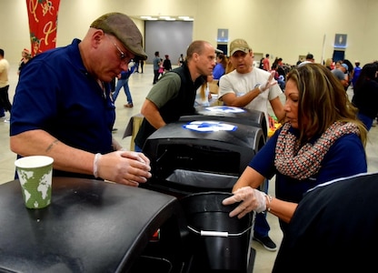 Chief Master Sgt. Tony Rittwager, 433rd Maintenance Operations Squadron superintendent, and his wife Diane, sort through recyclable plastic and aluminum during H-E-B’s 26th Annual Feast of Sharing Dec. 23, 2018, at the Henry B. Gonzalez Convention Center in San Antonio, Texas. Spouses, children, friends and family served food and drinks, cleaned tables, sorted recyclables and provided fellowship to the assembled guests, who came from throughout the Military City U.S.A area to share the dinner.