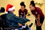 Identical twins, Airmen 1st Class Maranda Smith, 433rd Aerospace Medicine Squadron health services technician and Mariah Smith, 433rd Force Support Squadron communications technician, talk with a guest at H-E-B’s 26th Annual Feast of Sharing Dec. 23, 2018, at the Henry B. Gonzalez Convention Center in San Antonio, Texas. This was the Smith sisters first time serving at the event that served over 10,000 meals to area resident from the Alamo City area.