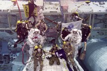 Army astronauts Col. Andrew “Drew” Morgan and Lt. Col. Anne McClain, both from the astronaut class of 2013, prepare to be promoted while underwater following required training in the Neutral Buoyancy Laboratory at the Sonny Carter Training Facility in Houston, Texas, Sept. 27. (NASA Neutral Buoyancy Laboratory photo)