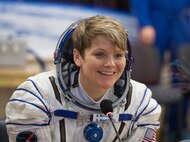 Expedition 58 Flight Engineer Anne McClain of NASA speaks with friends and family after having her Russian Sokol suit pressure checked in preparation for her launch aboard the Soyuz MS-11 spacecraft on Monday, Dec. 3, 2018, at the Baikonur Cosmodrome in Kazakhstan. Launch of the Soyuz rocket is scheduled for the same day and will carry McClain, Soyuz Commander Oleg Kononenko of Roscosmos, and Flight Engineer David Saint-Jacques of the Canadian Space Agency (CSA) into orbit to begin their six and a half month mission on the International Space Station. Photo Credit: (NASA/Aubrey Gemignani)