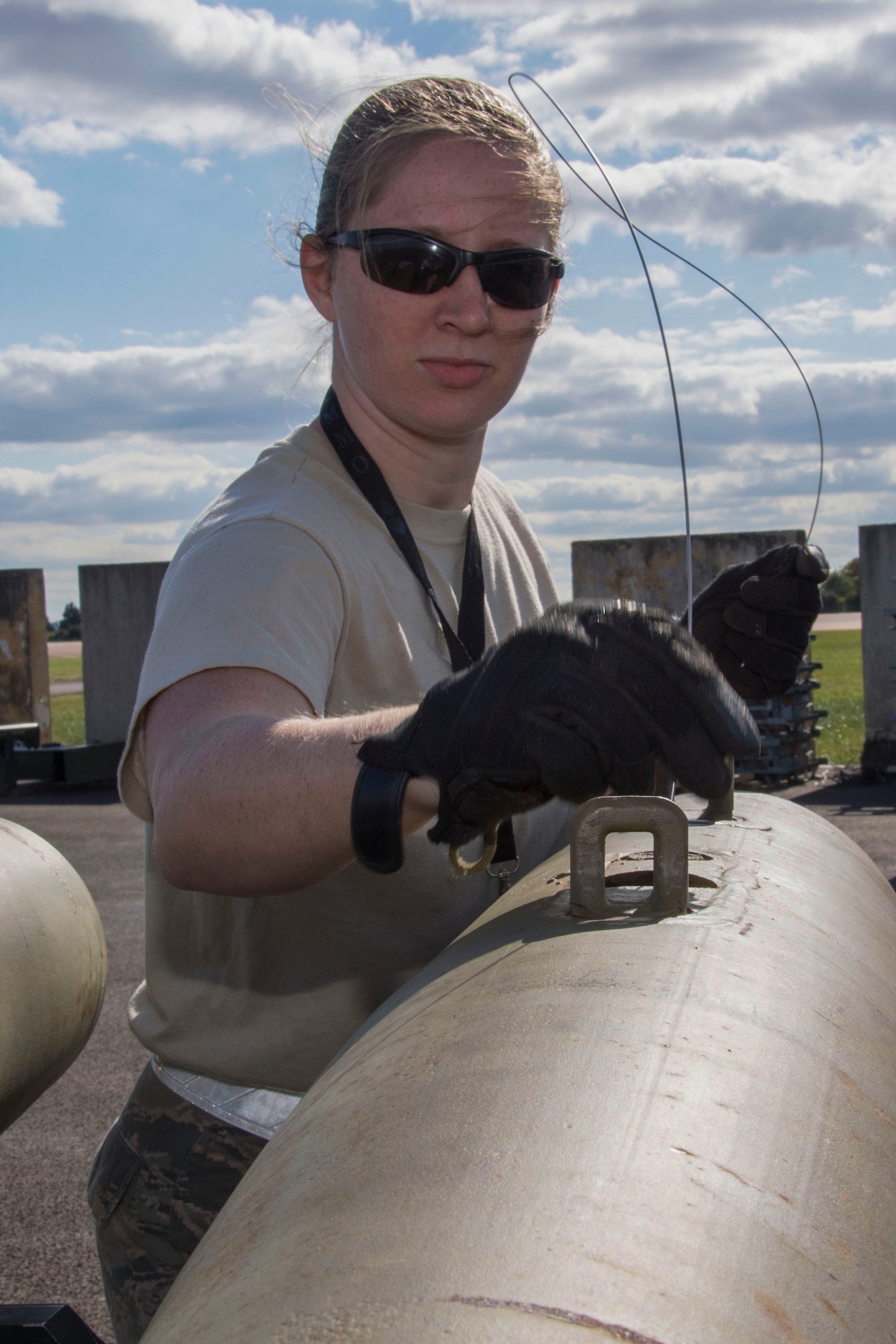 U.S. Air Force Staff Sgt. Ashley Johnson, a munitions technician assigned to the 707th Maintenance Squadron, performs maintenance on a munition during Ample Strike 18 at Royal Air Force Fairford, England, Sept. 7, 2018.   When not building munitions, Johnson can be found practicing her love of art. (U.S. Air Force photo by Master Sgt. Ted Daigle)
