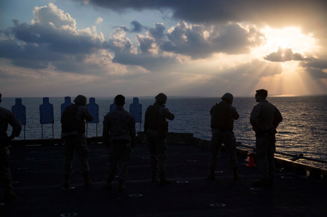 U.S. Marines with the Command Element, 13th Marine Expeditionary Unit, fire on their targets during a morning rifle range aboard the Wasp-class amphibious assault ship USS Essex, Jan. 2, 2019. The Essex is the flagship for the Essex Amphibious Ready Group and, with the embarked 13th MEU, is deployed to the U.S. 5th Fleet area of operations in support of naval operations to ensure maritime stability in the Central Region, connecting the Mediterranean and the Pacific through the western Indian Ocean and three strategic choke points.