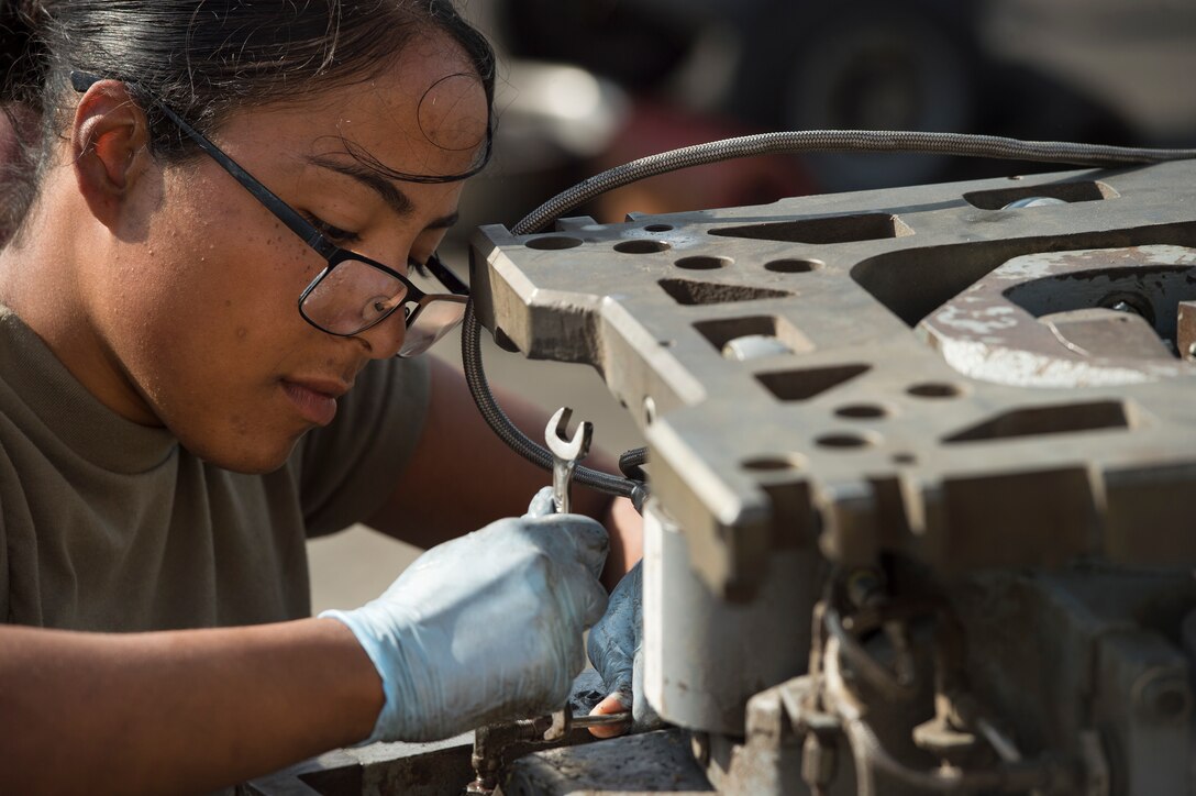 Airman 1st Class Annaliz Rodriguez, 379th Expeditionary Maintenance Squadron aerospace ground equipment (AGE) journeyman, fixes a leak found during routine maintenance for a bomb lift Jan. 4, 2018, at Al Udeid Air Base, Qatar. AGE Airmen here perform maintenance on a variety of aircraft equipment including bomb lifts, hydraulic test stands, air conditioners, heaters and power carts. (U.S. Air Force photo by Tech. Sgt. Christopher Hubenthal)