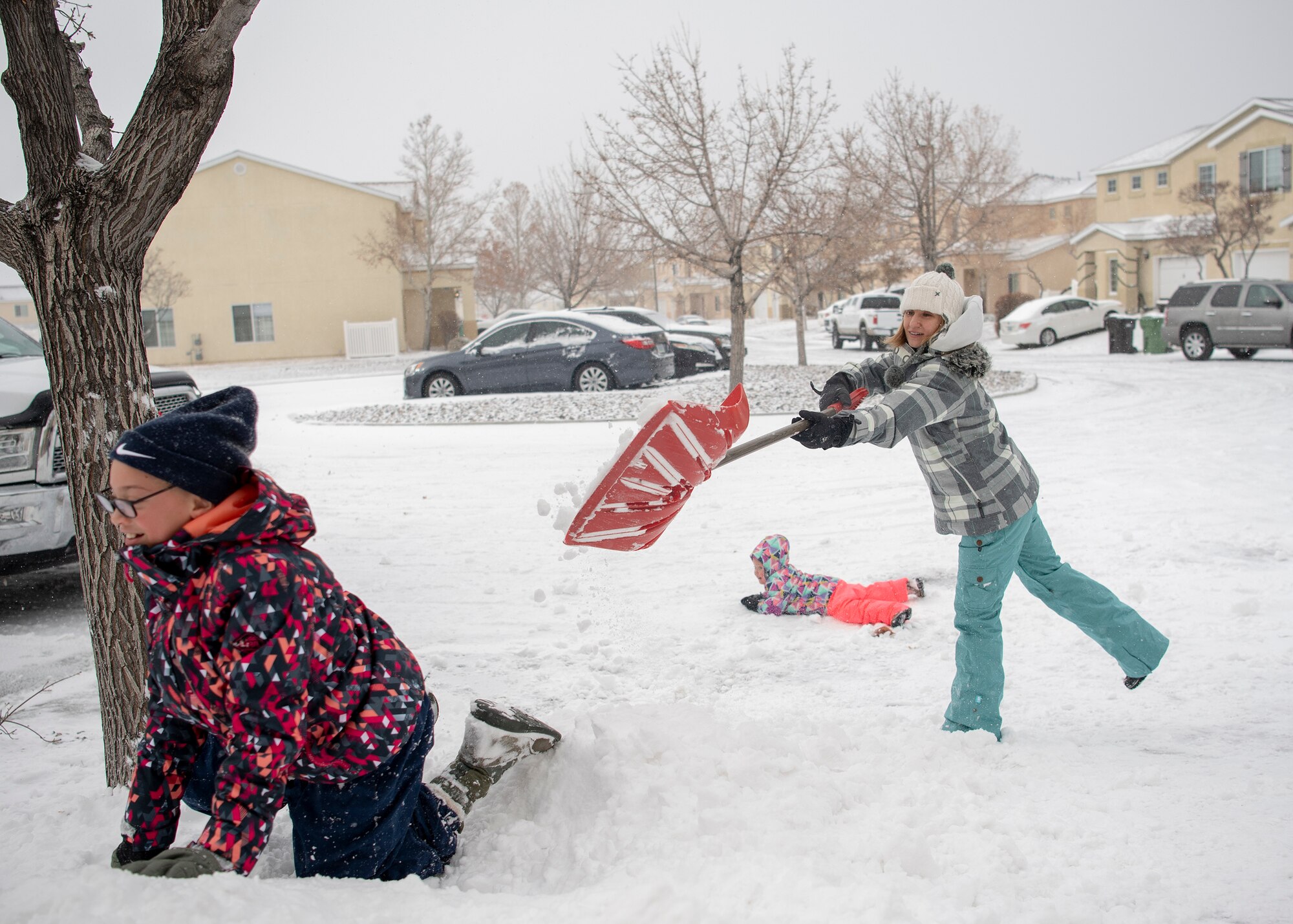 Tech. Sgt Kimberly Strong, Space Rapid Capabilities Office directors action group noncommissioned officer in charge, plays with her daughters Peyton 10, left and Cadence Strong 3, after a snowstorm that blanketed the Albuquerque area and prompted closure of Kirtland Air Force Base to non-mission essential personnel on Dec. 27, 2018.