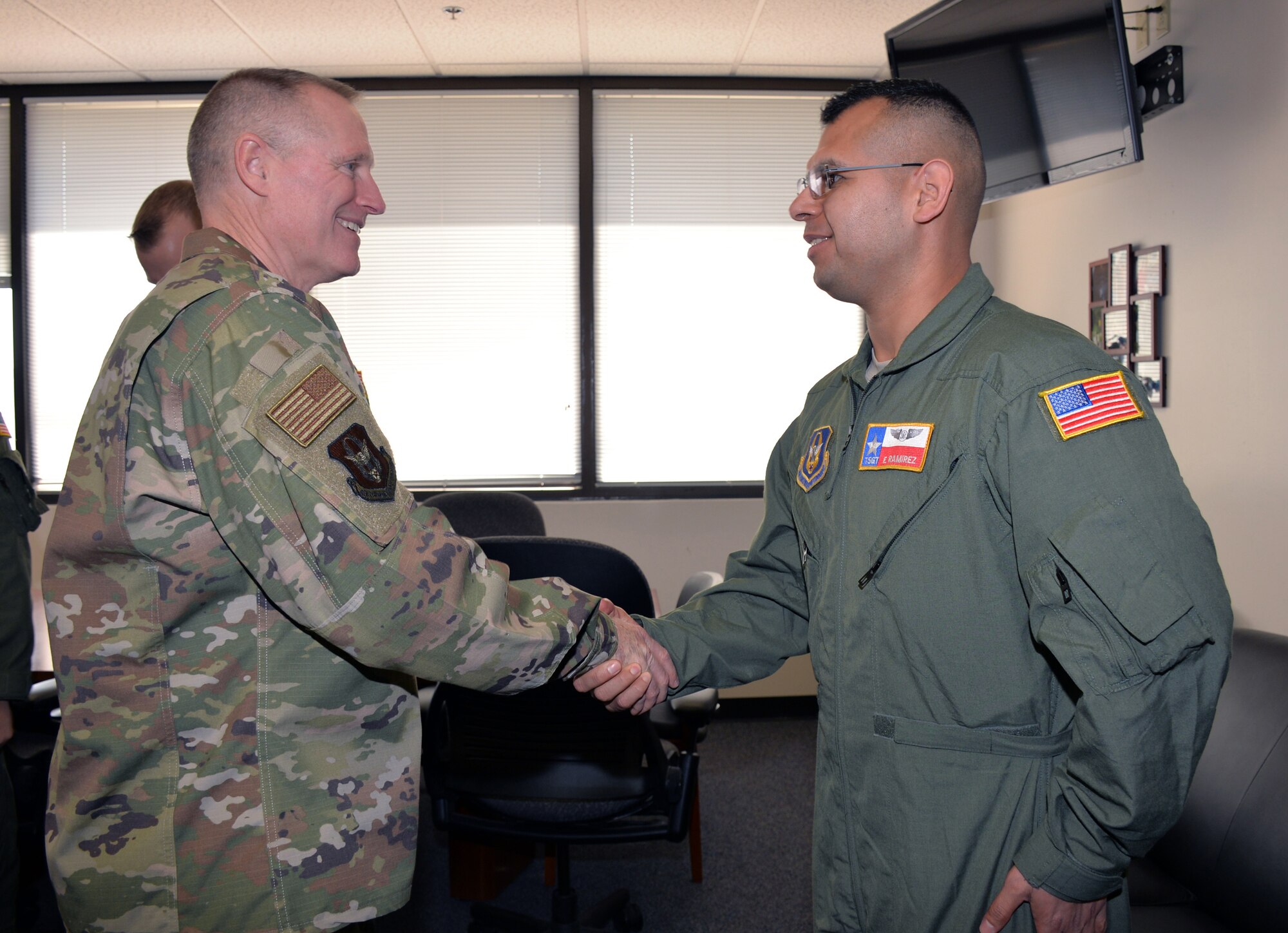 Maj. Gen. Kenneth D. Lewis Jr., Air Force Reserve Command deputy commander, presents a coin to Tech. Sgt. Edgar Ramirez, 433rd Aeromedical Evacuation Squadron, Jan. 3, 2018 at Joint Base San Antonio-Lackland, Texas