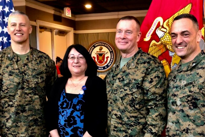Col. William Bentley (left), the commanding officer of Marine Corps Base Quantico, Elaine Marsh, Brig. Gen. David Maxwell, the assistant deputy commandant for Installations and Logistics, and Col. Joseph Murray, the commander of Marine Corps Installations National Capital Region, pose for a photo during Elaine’s retirement at Lejeune Hall aboard MCB Quantico, Virginia, January 3, 2019. Elaine served as a federal employee for 31 years and 11 months.