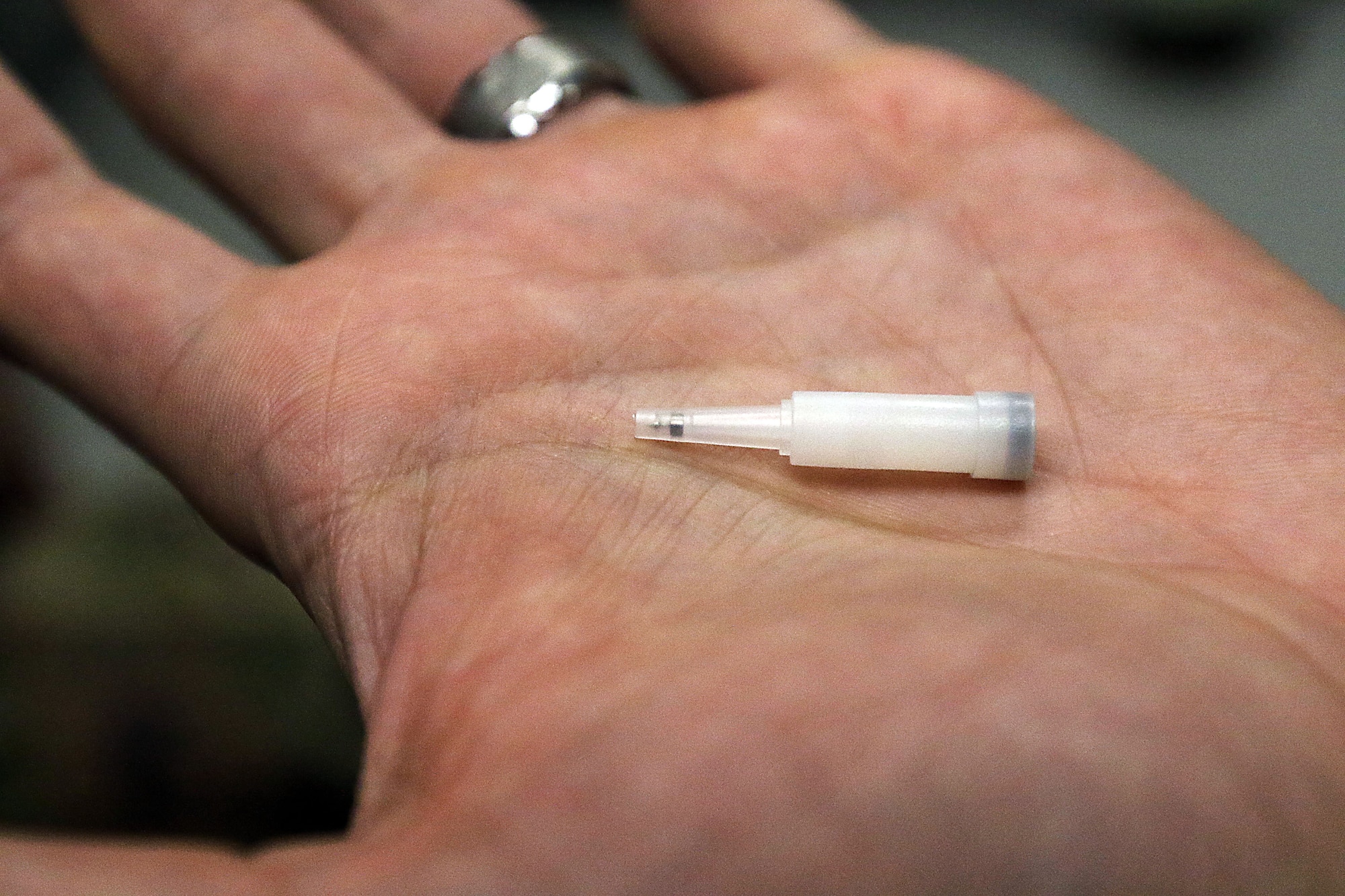 Inside the plastic container is the type of needle used in Battlefield Acupuncture. It is 1 millimeter in length and is either gold-plated or made of steel.