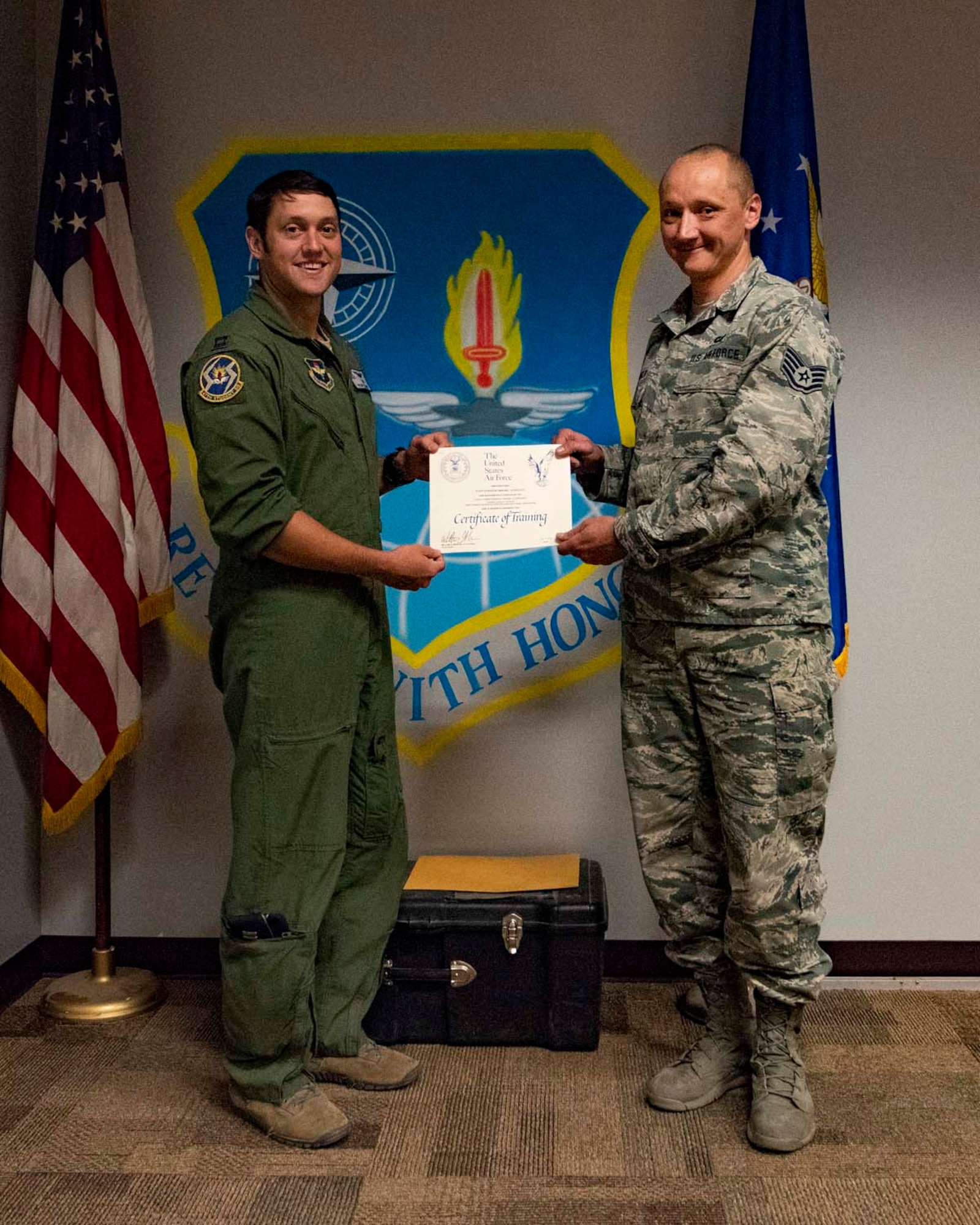 Staff Sgt. Mikhail Scheglov, a finance technician with the 141st Comptroller Flight, poses with Capt. Ryan Adams, a pilot with the 58th Training Squadron, during their graduation ceremony upon completing the Survival, Evasion, Resistance and Escape SV-80A combat survival training course. Scheglov completed several SERE training courses in preparation for a trip to Vinnytsia Air Base, Ukraine, in which he served as a translator during exercise Clear Sky 2018.  (U.S. Air National Guard photo by Staff Sgt. Rose M. Lust)