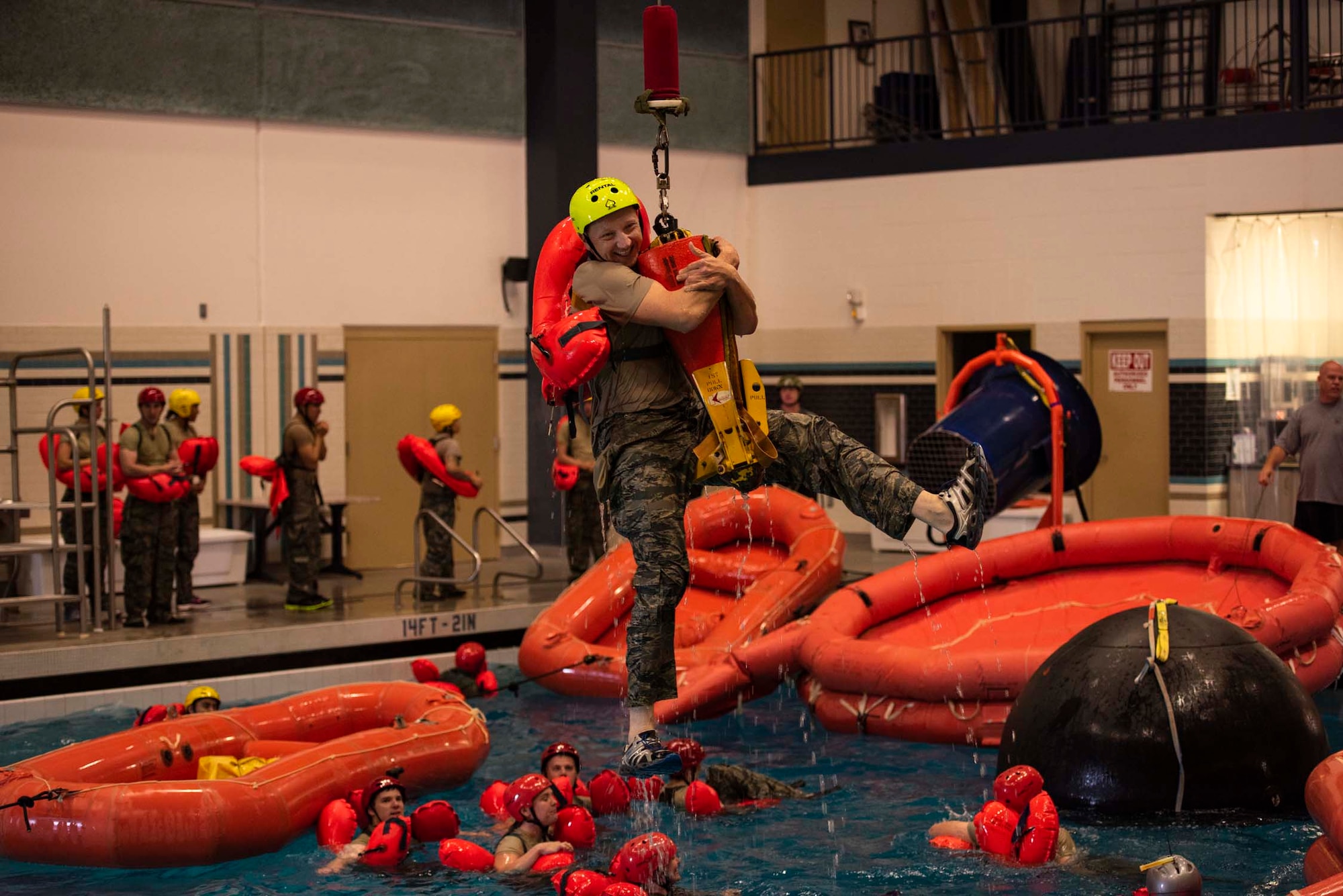 Staff Sgt. Mikhail Scheglov, a finance technician with the 141st Comptroller Flight, smiles as he’s hoisted out of the pool during SV-90A parachute water survival training Aug. 2, 2018 at Fairchild Air Force Base, Wash. Scheglov completed several Survival, Evasion, Resistance and Escape training courses in preparation for a trip to Vinnytsia Air Base, Ukraine, in which he served as a translator during exercise Clear Sky 2018. (U.S. Air National Guard photo by Staff Sgt. Rose M. Lust)