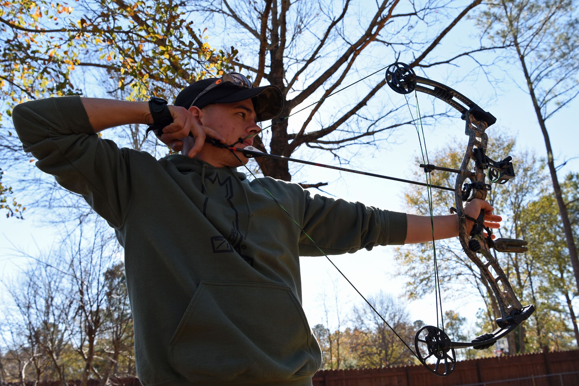 U.S. Air Force Airman 1st Class Noah Rachau, 20th Aircraft Maintenance Squadron crew chief, draws an arrow at his residence in Sumter, S.C., Dec. 22, 2018.