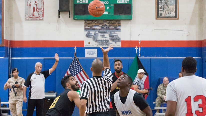 U.S. Army Soldiers with Area Support Group - Kuwait basketball team and Kuwaiti soldiers assigned to the 94th Mechanized Infantry Brigade start the first game of the 2018 Kuwaiti-US basketball tournament at Camp Arifjan, Kuwait, Oct. 26, 2018. Participating in these kind of events demonstrates our enduring commitment to our host nation partnership and develops good Soldier morale.