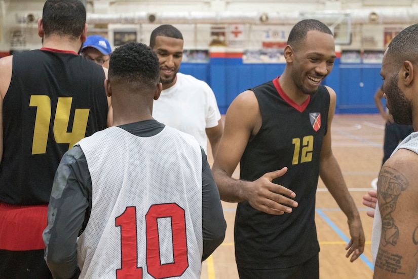U.S. Army Soldiers with Area Support Group - Kuwait basketball team and the Kuwait Army's 94th Mechanized Infantry Brigade congratulate each other at the end of the 2018 Kuwaiti-US basketball tournament hosted by Area Support Group - Kuwait in Camp Arifjan, Kuwait, Dec. 29, 2018. Participating in these kind of events help build cohesion between partner nations while allowing soldiers to relax and have fun.
