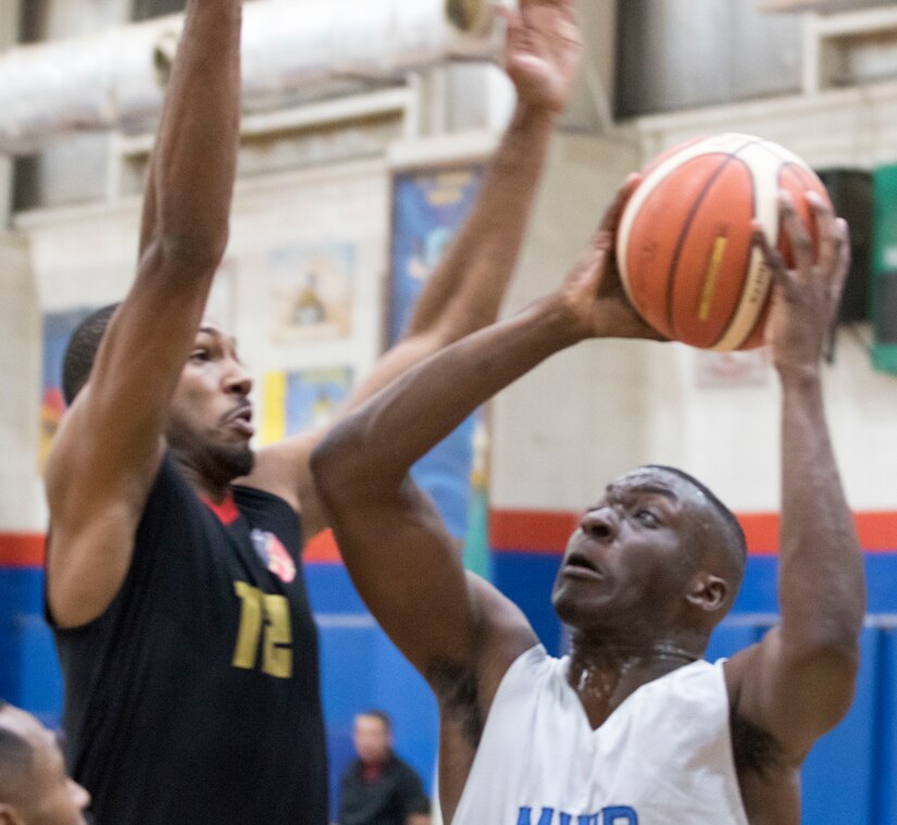 U.S. Army Spc. Cadarius Brantley, a signal support systems specialist with the 75th Explosive Ordnance Disposal Company, takes a shot at the 2018 Kuwaiti-US basketball tournament hosted by Area Support Group - Kuwait at Camp Arifjan, Kuwait, Dec. 29, 2018. Participating in these kind of events demonstrates our enduring commitment to our host nation partnership and develops good Soldier morale.