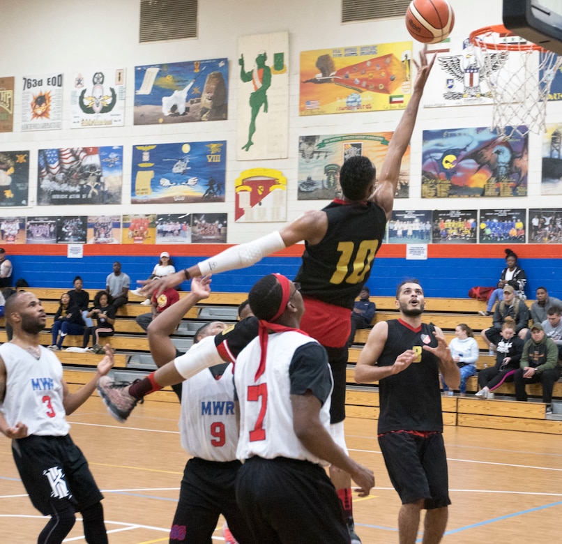 A soldier with the 94th Mechanized Infantry Brigade, Kuwait Army, attempts a layup at the 2018 Kuwaiti-US basketball tournament hosted by Area Support Group - Kuwait at Camp Arifjan, Kuwait, Dec. 29, 2018. Strengthening the relationship with our host nation is paramount to our overall mission.