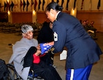 Rebecca Oduba, left, grandmother of Army Lt. Col. Thomas E. Wooden Jr., receives an American flag in honor of her grandson's retirement Jan. 4, 2018 in Philadelphia.