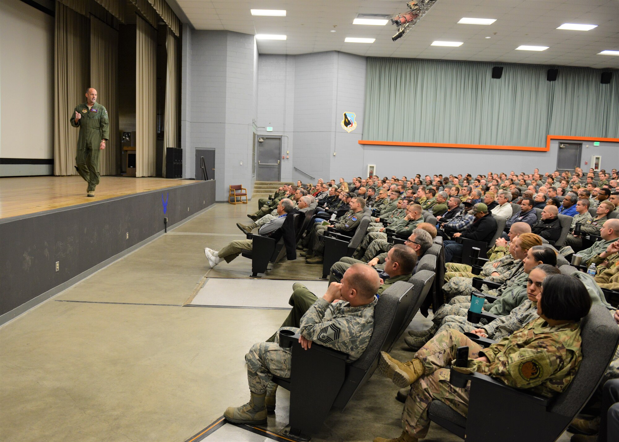 Brig. Gen. E. John Teichert, 412th Test Wing commander, addresses a packed base theater Jan. 2 for the wing’s annual Back in the Saddle event. (U.S. Air Force photo by Kenji Thuloweit)