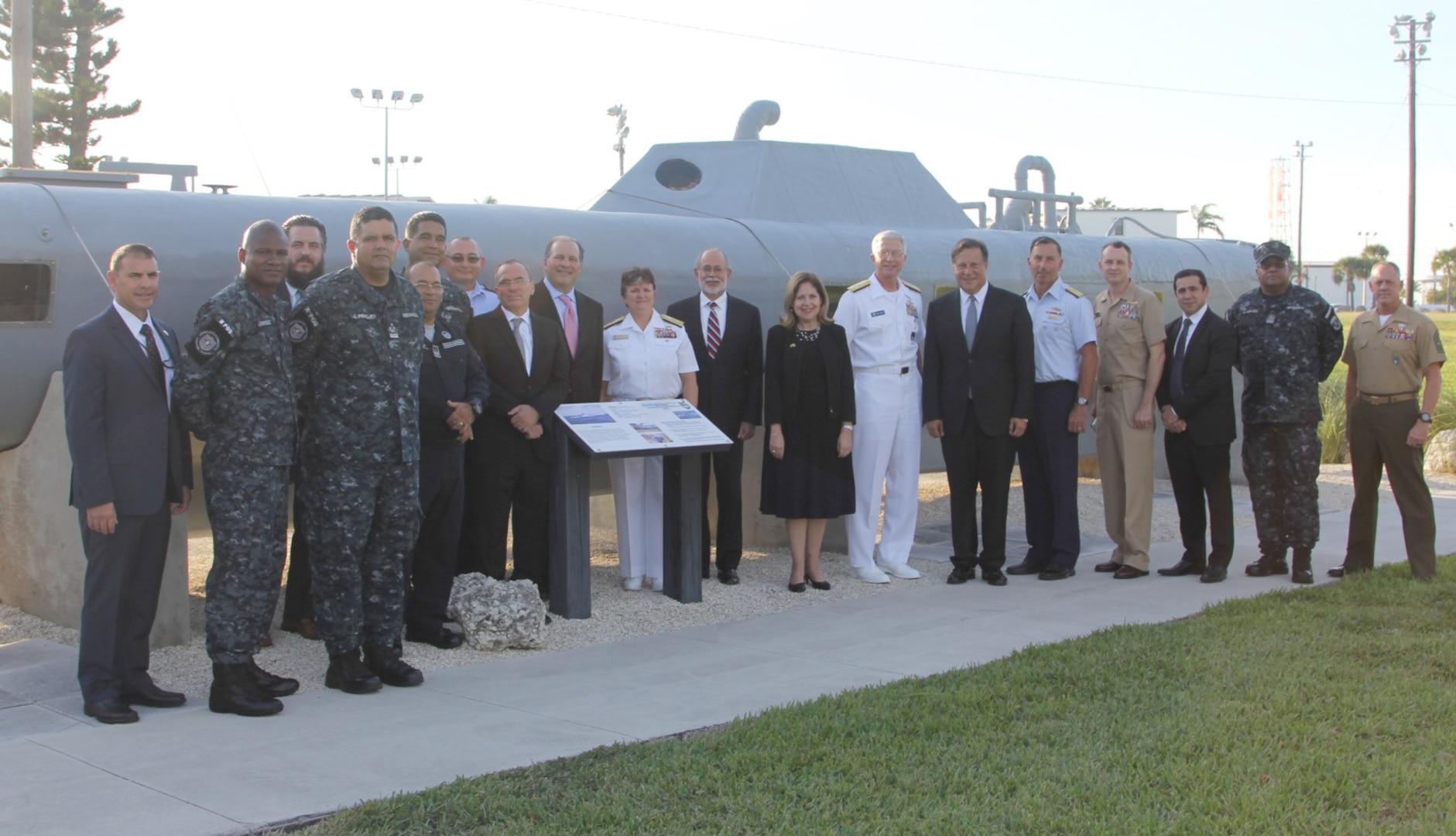 Panamanian President Juan Carlos Varela and U.S. and international leaders in front of a static display of a self-propelled semi-submersible (SPSS), located outside JIATF South.