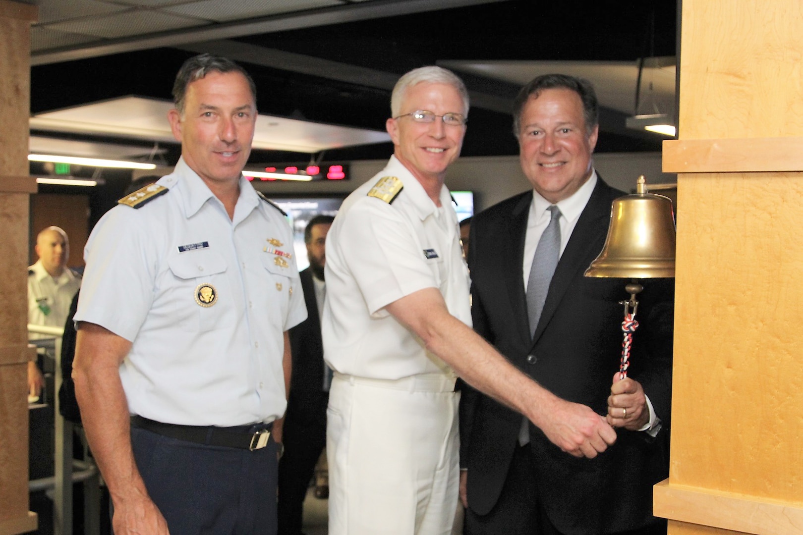 Panamanian President Juan Carlos Varela rings the JIATF South joint operations center (JOC) floor bell alongside Navy Adm. Craig Faller, Commander of U.S. Southern Command, and Coast Guard Rear Adm. Pat DeQuattro, JIATF South Director.