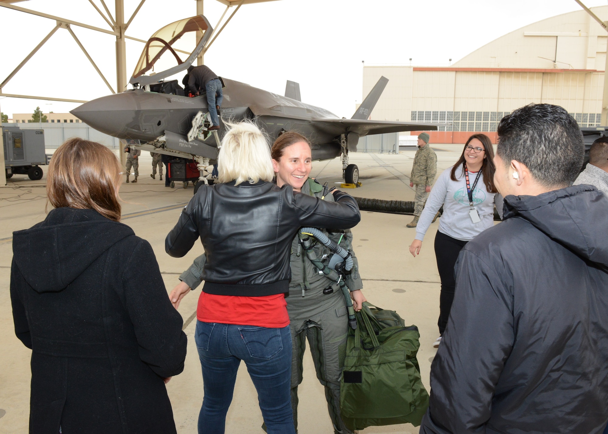 Maj. Rachael Winiecki, 461st Flight Test Squadron F-35 test pilot, is greeted by members of her squadron right after she landed her F-35 Lightning II following her first test mission flight in the fifth-generation fighter Dec. 14, 2018. (U.S. Air Force photo by Kenji Thuloweit)